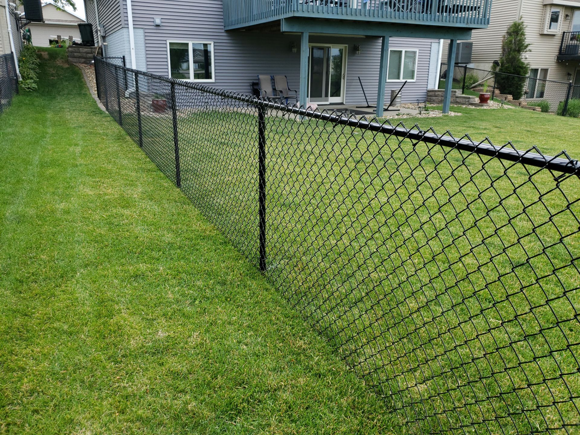 Black Vinyl Chain Link Perimeter Fence Installation in Waterloo by Perfect Picket Fence and Stain