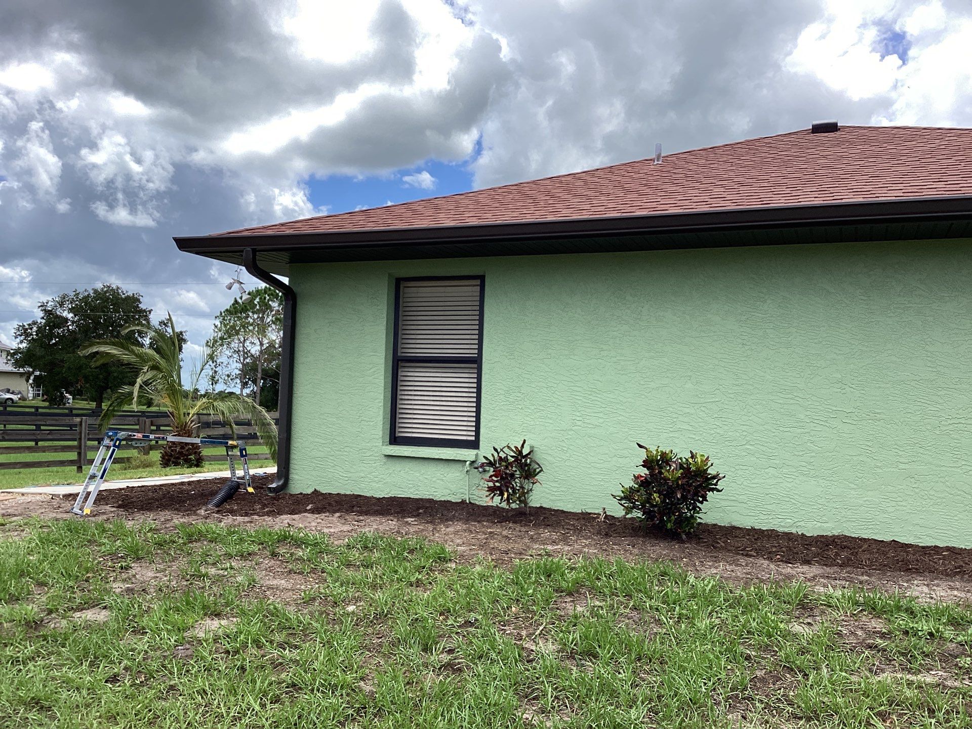 Musket brown downspouts with 6-inch K-Style gutter installation in Myakka City, FL by Gutter Professors