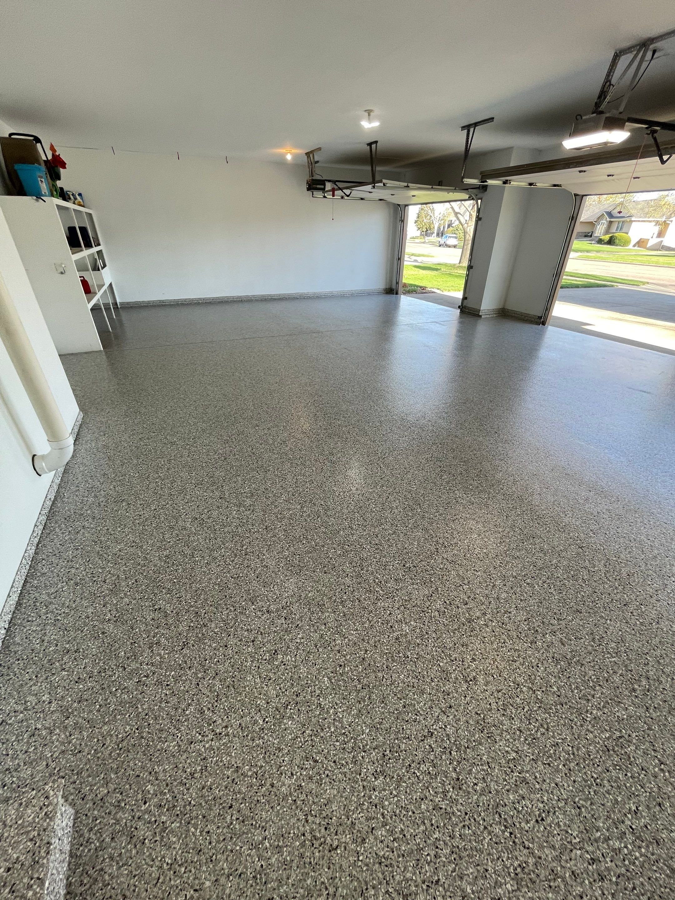 Yankton Garage Floor Restoration with Gray Speckled Epoxy Coating by Select Painting, Coatings & Garage Cabinets