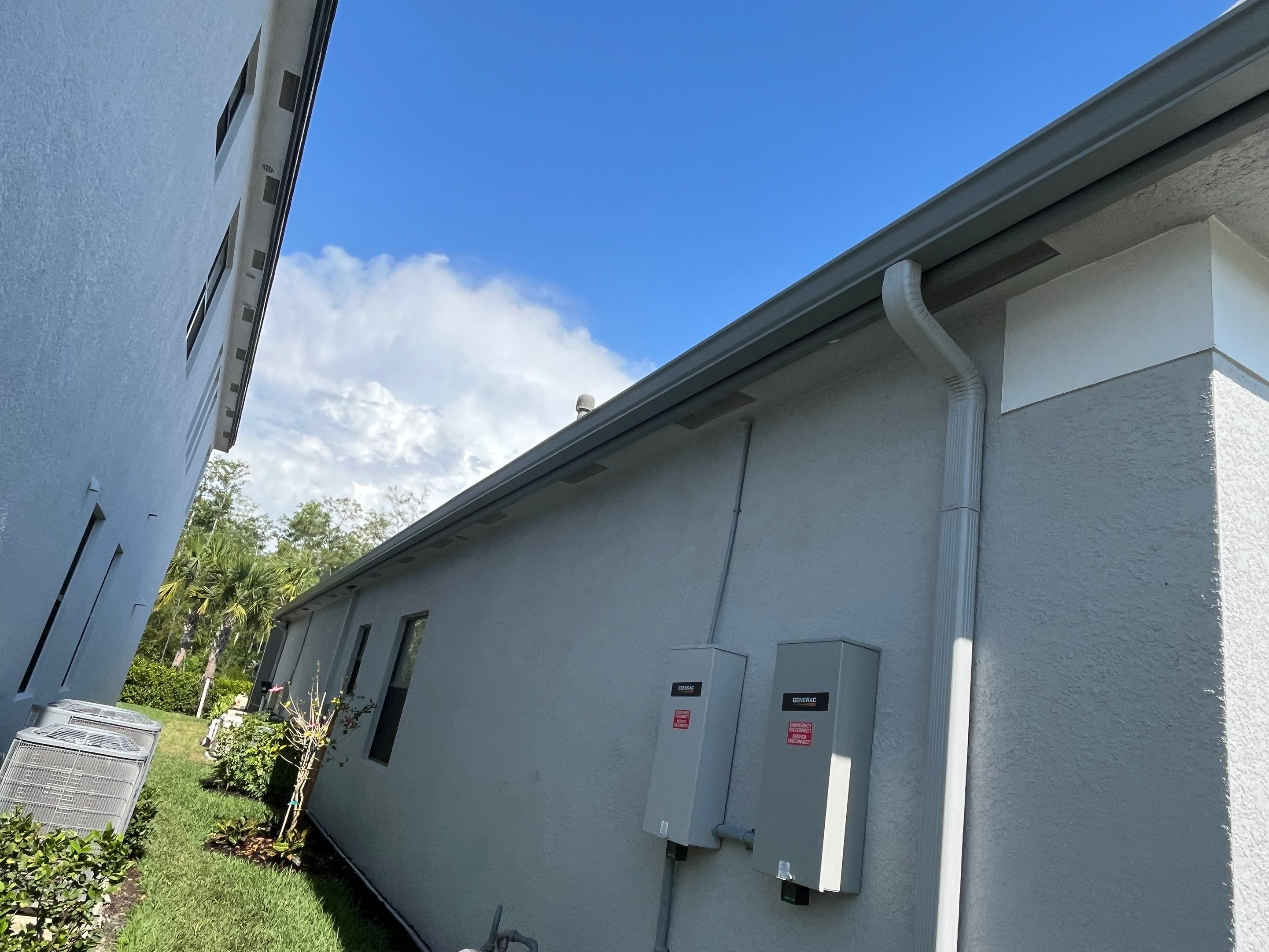 Grey Seamless Gutter Installation in Estero FL by Gutter Professors