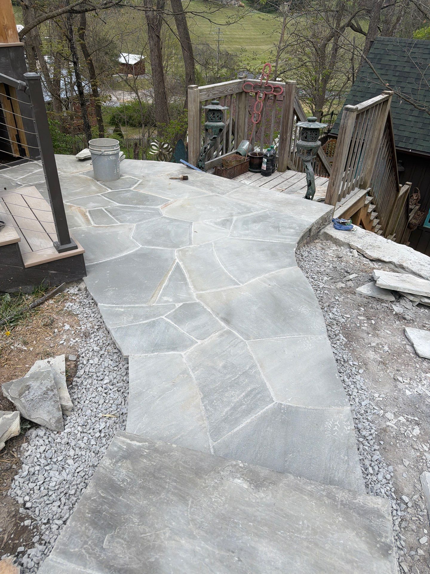 Custom Composite Deck with Stone Fireplace and Modern Cable Railing by Walnut Hollow Decks & Outdoor Living