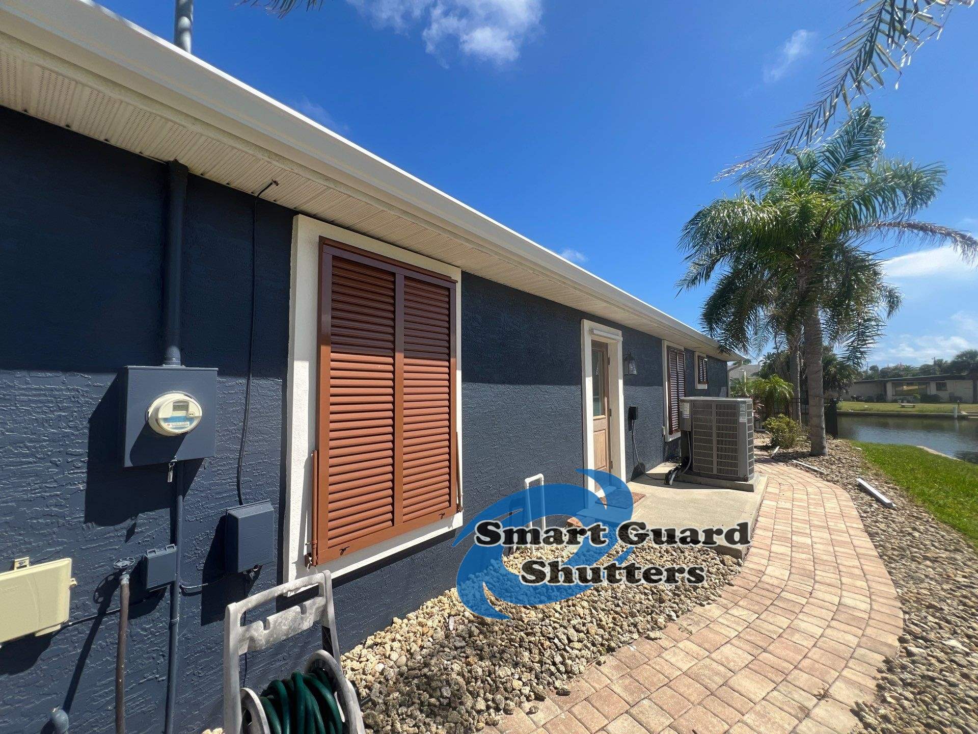 Impact Rated Bahama Shutters in Beige Brown by Smart Guard Shutters