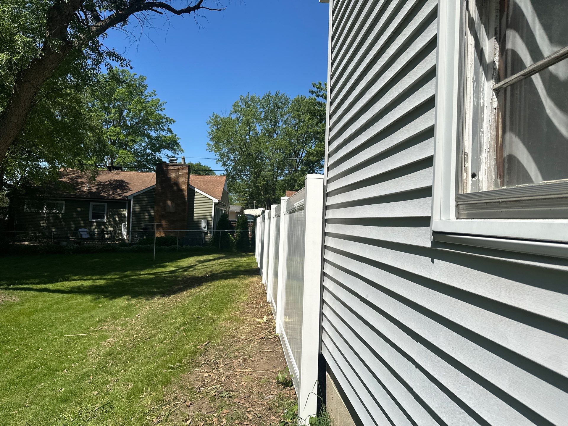 White Vinyl Privacy Fence and Double Gate Installation in Cedar Falls by Perfect Picket Fence and Stain