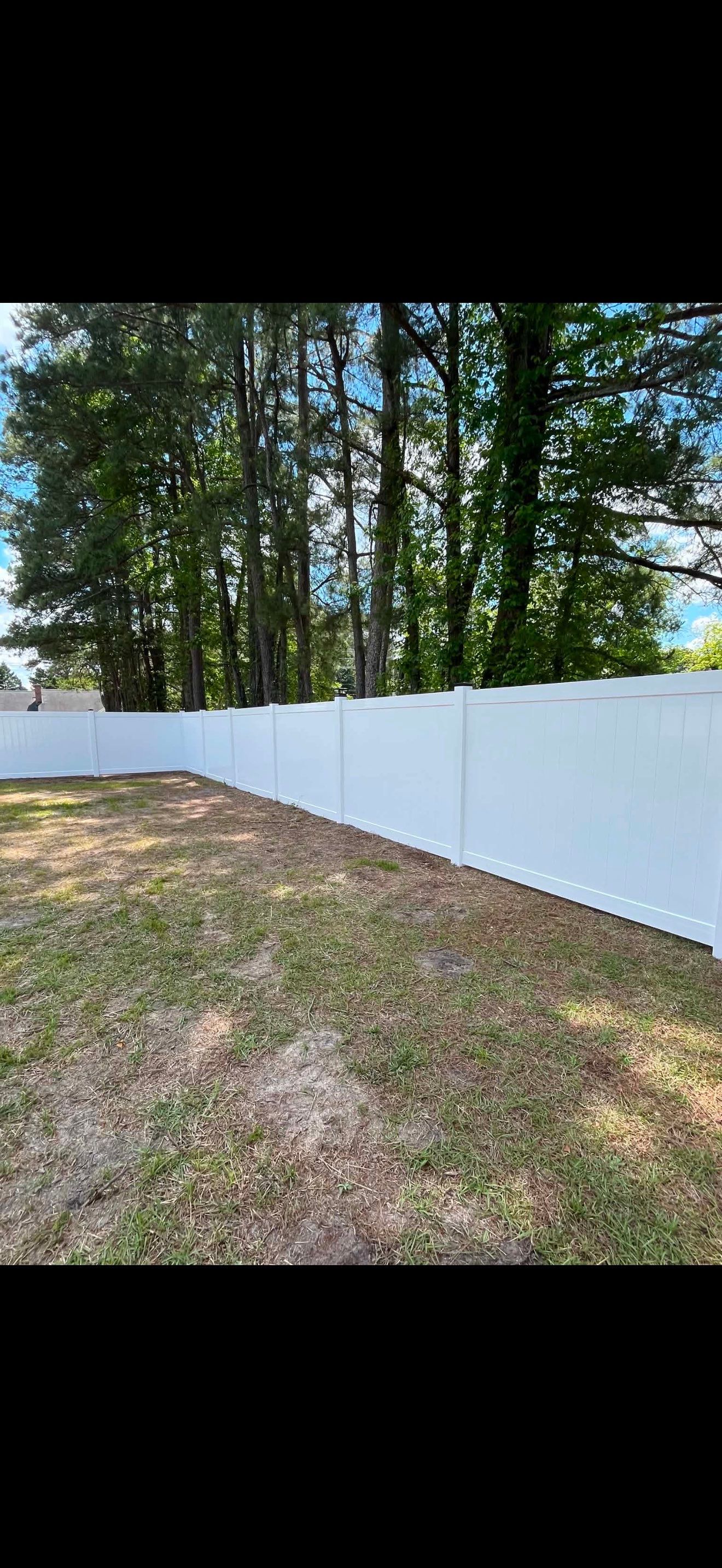 White Vinyl Privacy Fence with Solar Post Caps in Goldsboro by Superior Fence and Rail