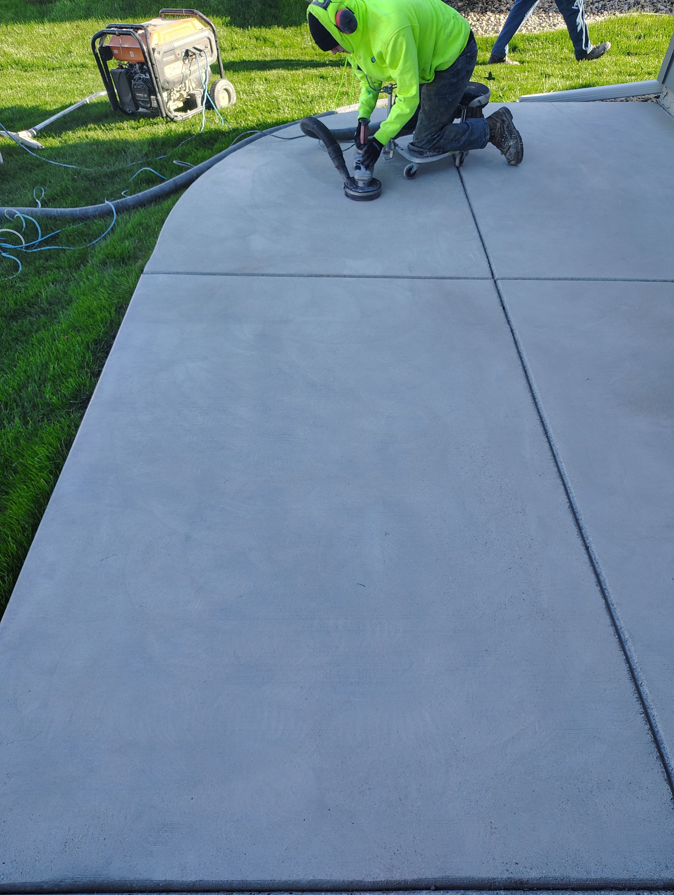 Speckled Concrete Patio Coating Installation in Sioux Falls by Select Painting, Coatings & Garage Cabinets