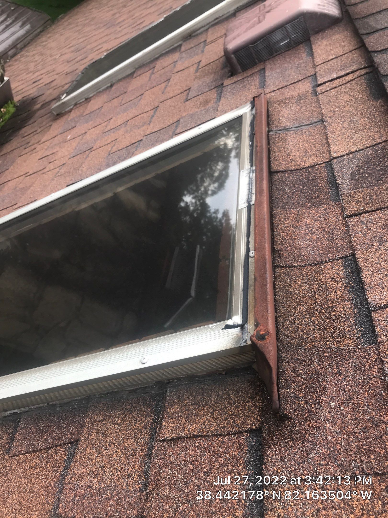 Shingle Roofing with Velux Skylight replacement and stone chimney flashing  by Secure Construction Company Inc