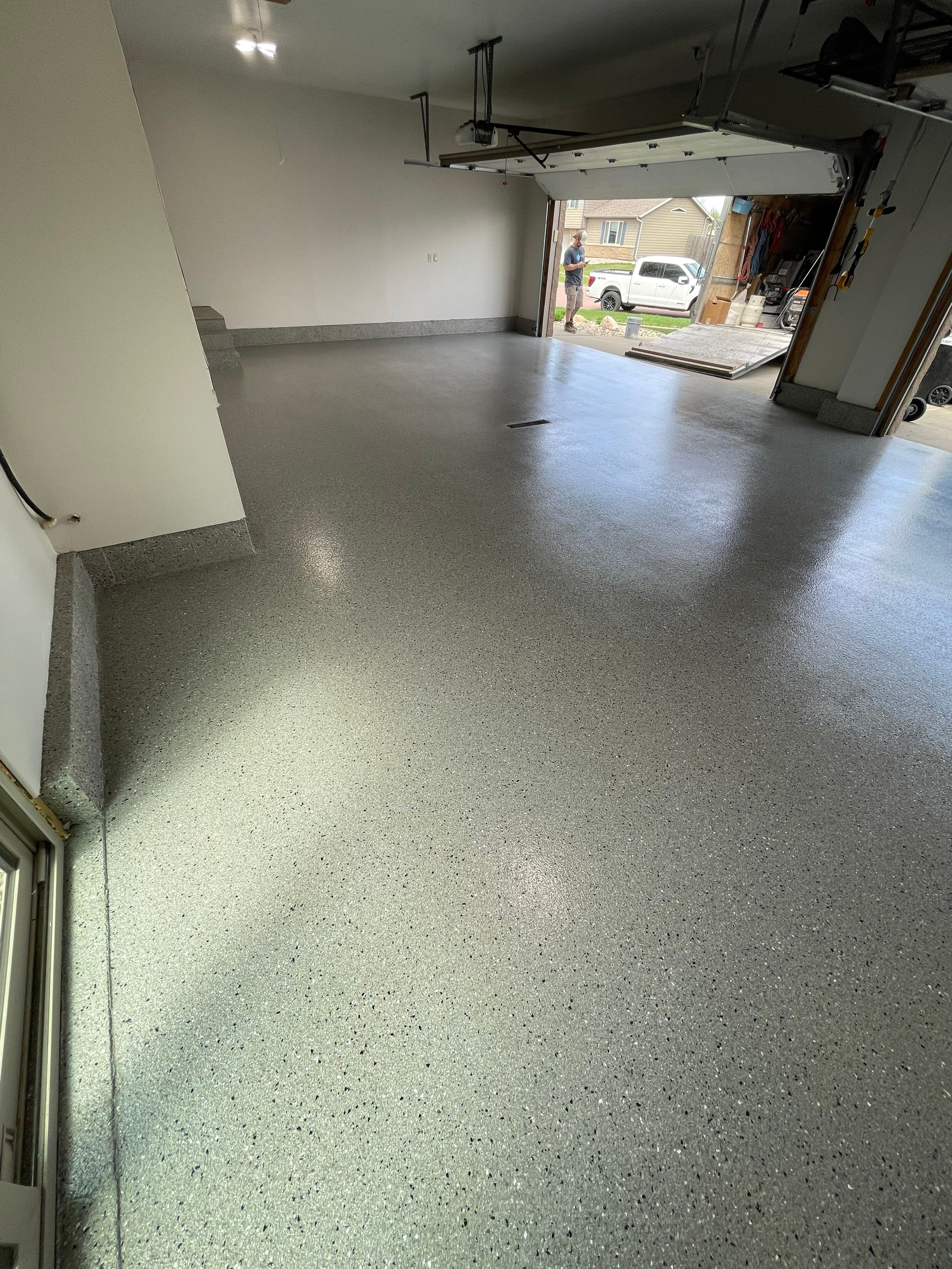 Residential Garage Floor Coating with Grey Speckled Epoxy Finish by Select Painting, Coatings & Garage Cabinets