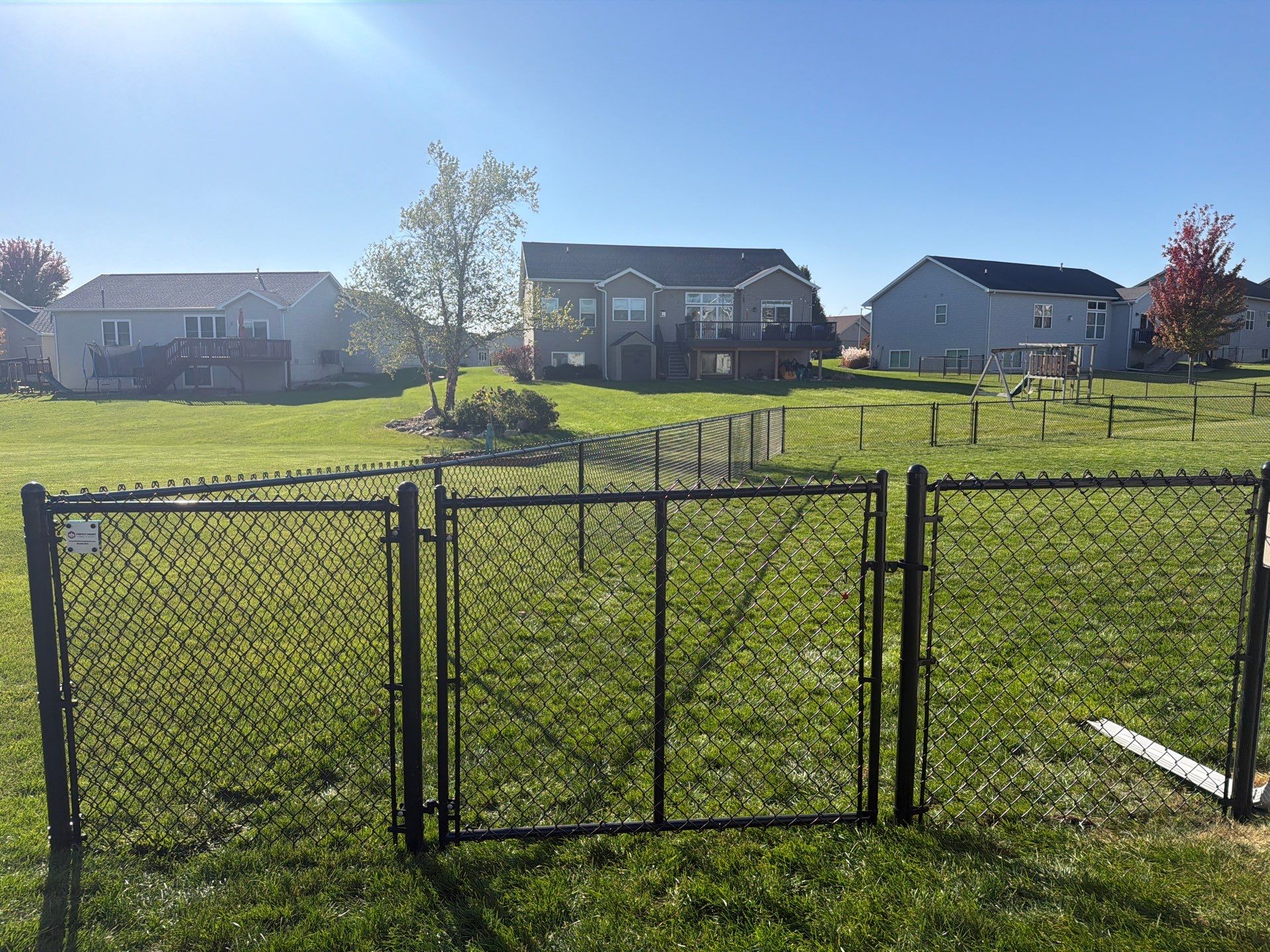 Black Vinyl-Coated Chain Link Fence Installation in Cedar Falls by Perfect Picket Fence and Stain