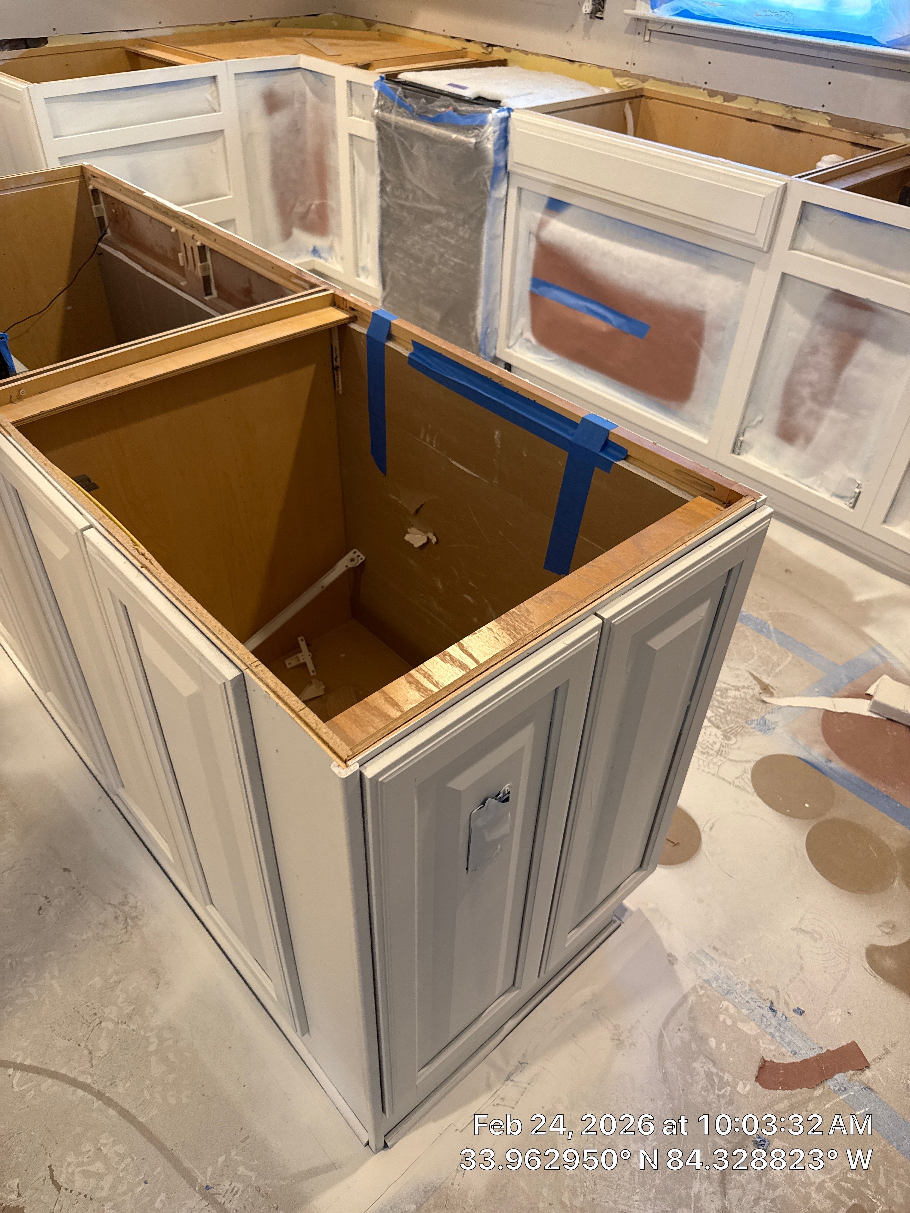Kitchen Remodel in Dunwoody Featuring White Cabinetry and Blue Island by Heart & Home Kitchen & Bath Remodeling LLC