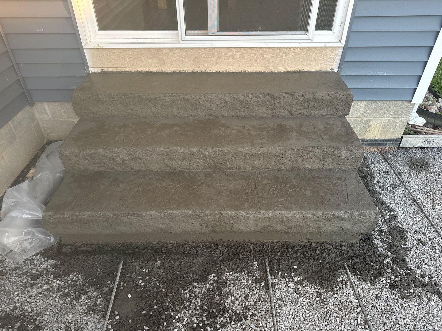 Majestic Ashlar stamped concrete patio with rock face steps  by NG Masonry & Construction LLC