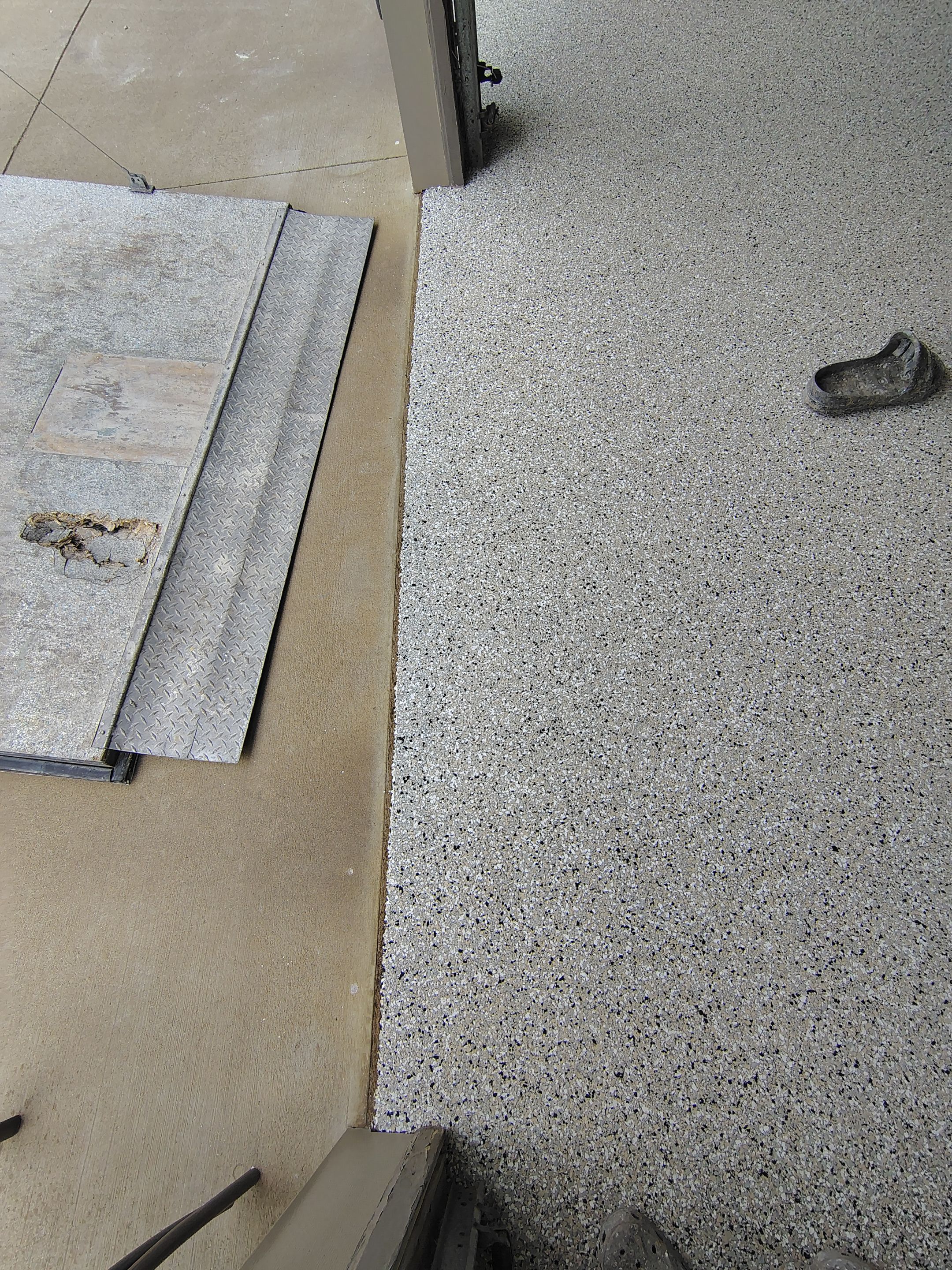 Full-Flake Epoxy Garage Floor Coating Installation in Sioux Falls by Select Painting, Coatings & Garage Cabinets