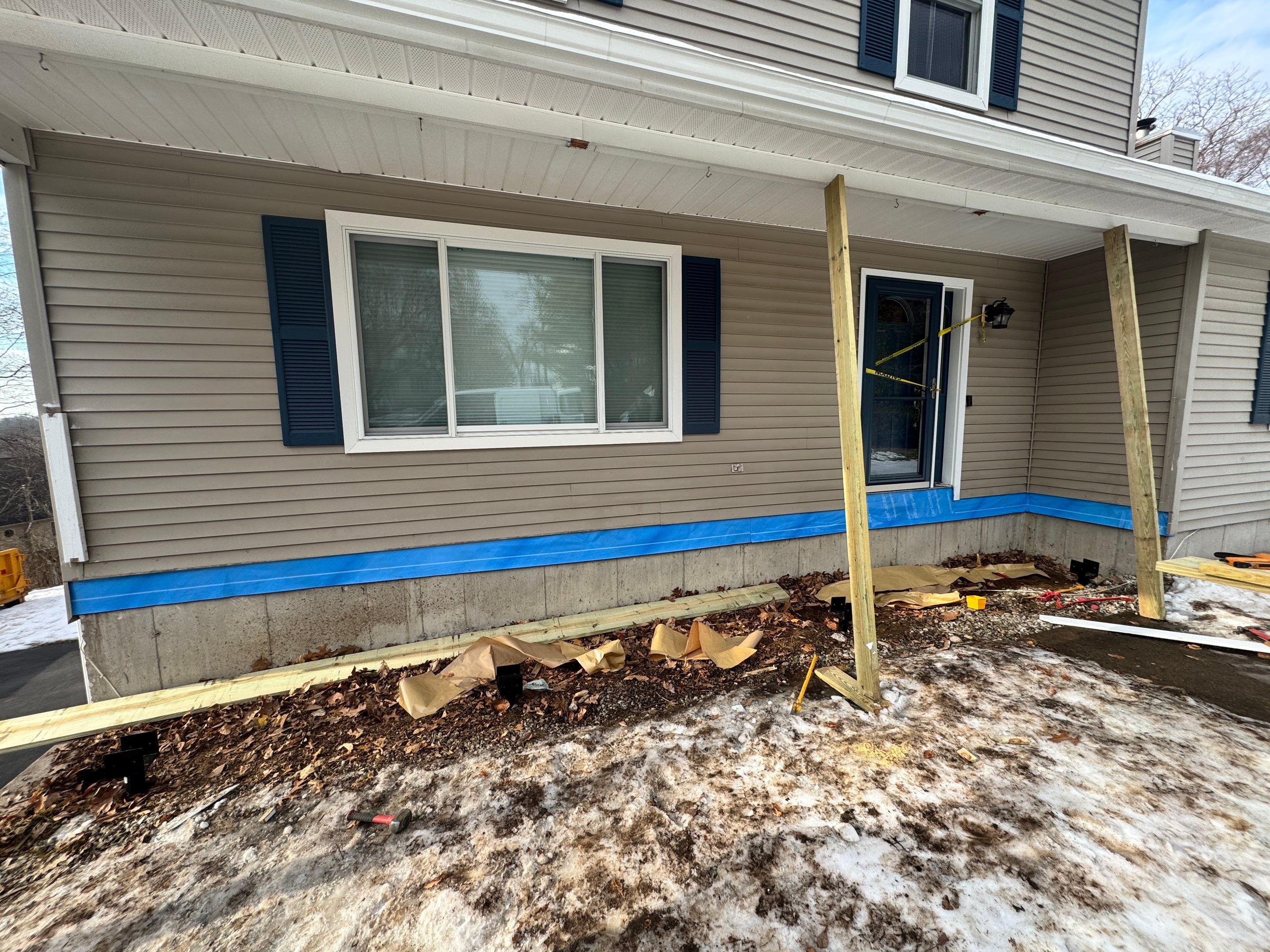Replacement front porch using Trex Tropical Island mist and White composite railings. Includes lattice bottom. by DiGiorgi Roofing and Siding Inc