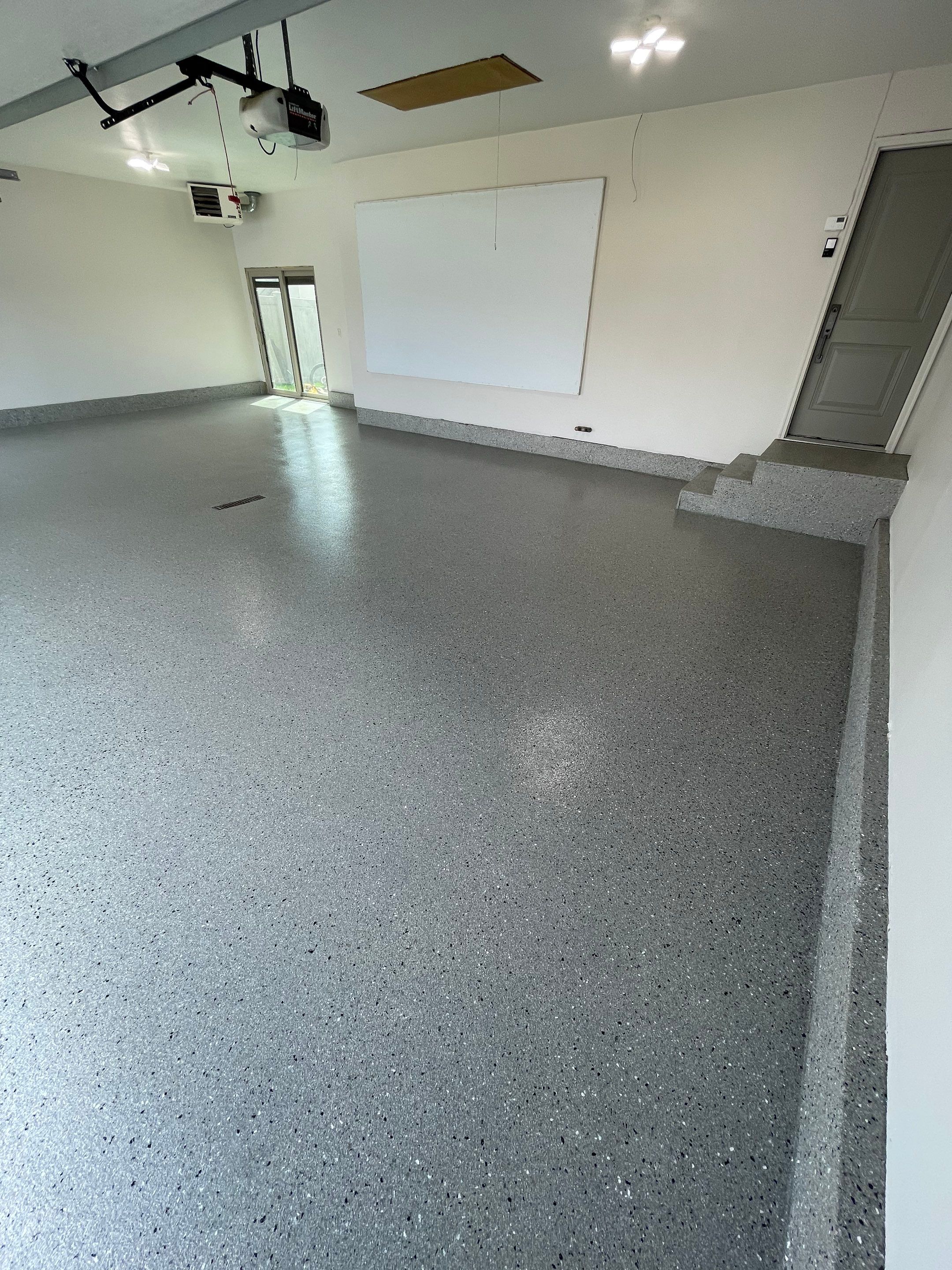 Residential Garage Floor Coating with Grey Speckled Epoxy Finish by Select Painting, Coatings & Garage Cabinets