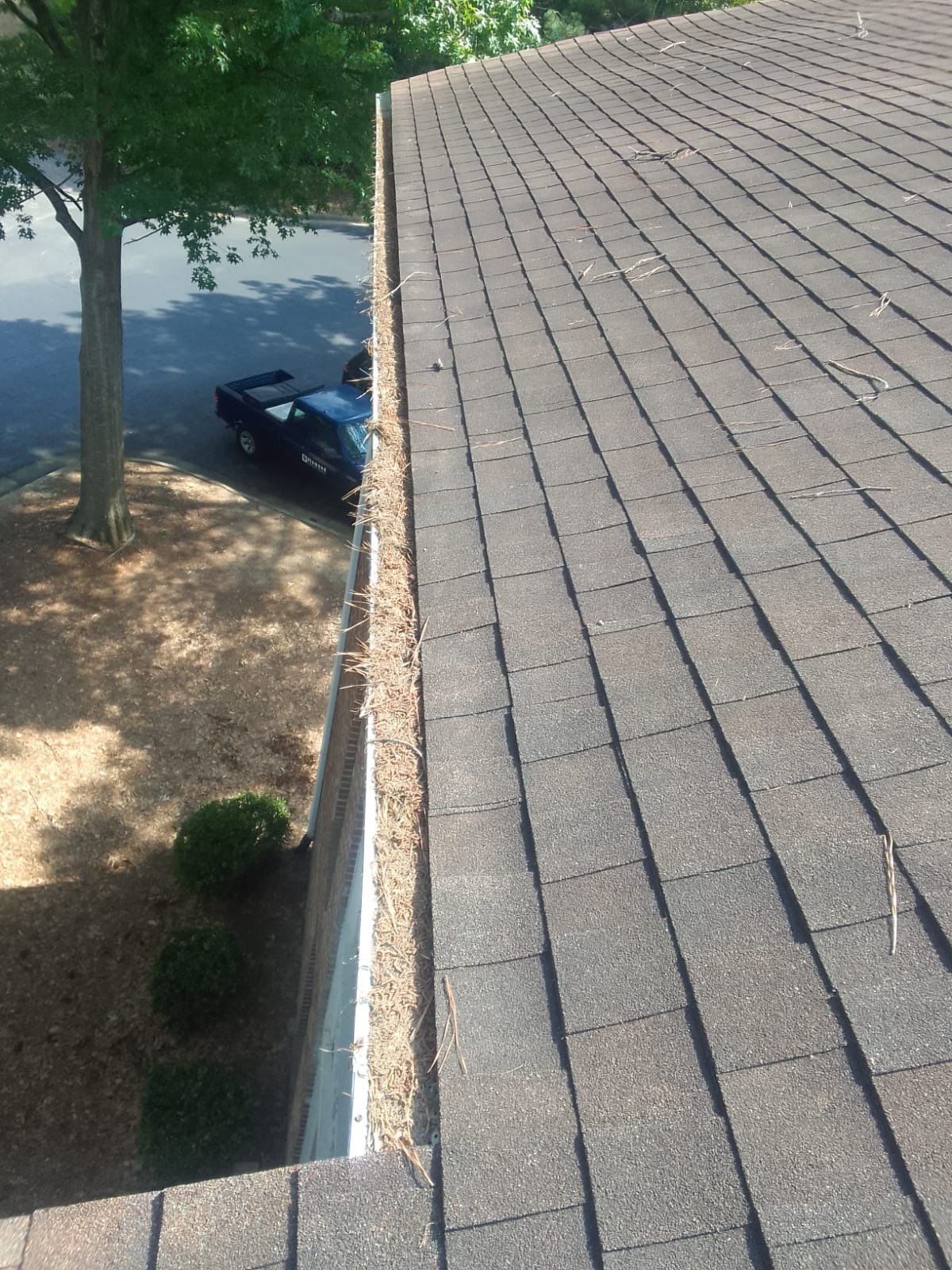 Commercial gutter cleaning Cary & Apex, NC before photo with filled gutters