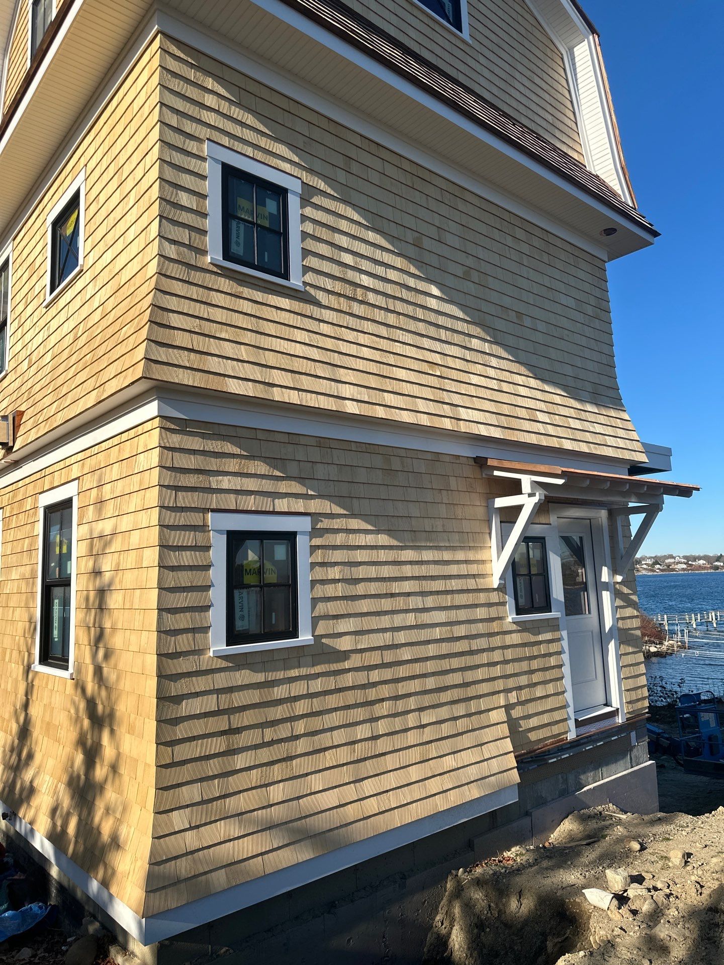 Great Island - Red Cedar Roofing, Yellow Cedar Siding, Standing Seam Copper, & Copper Gutters  by Rinaldi Brothers