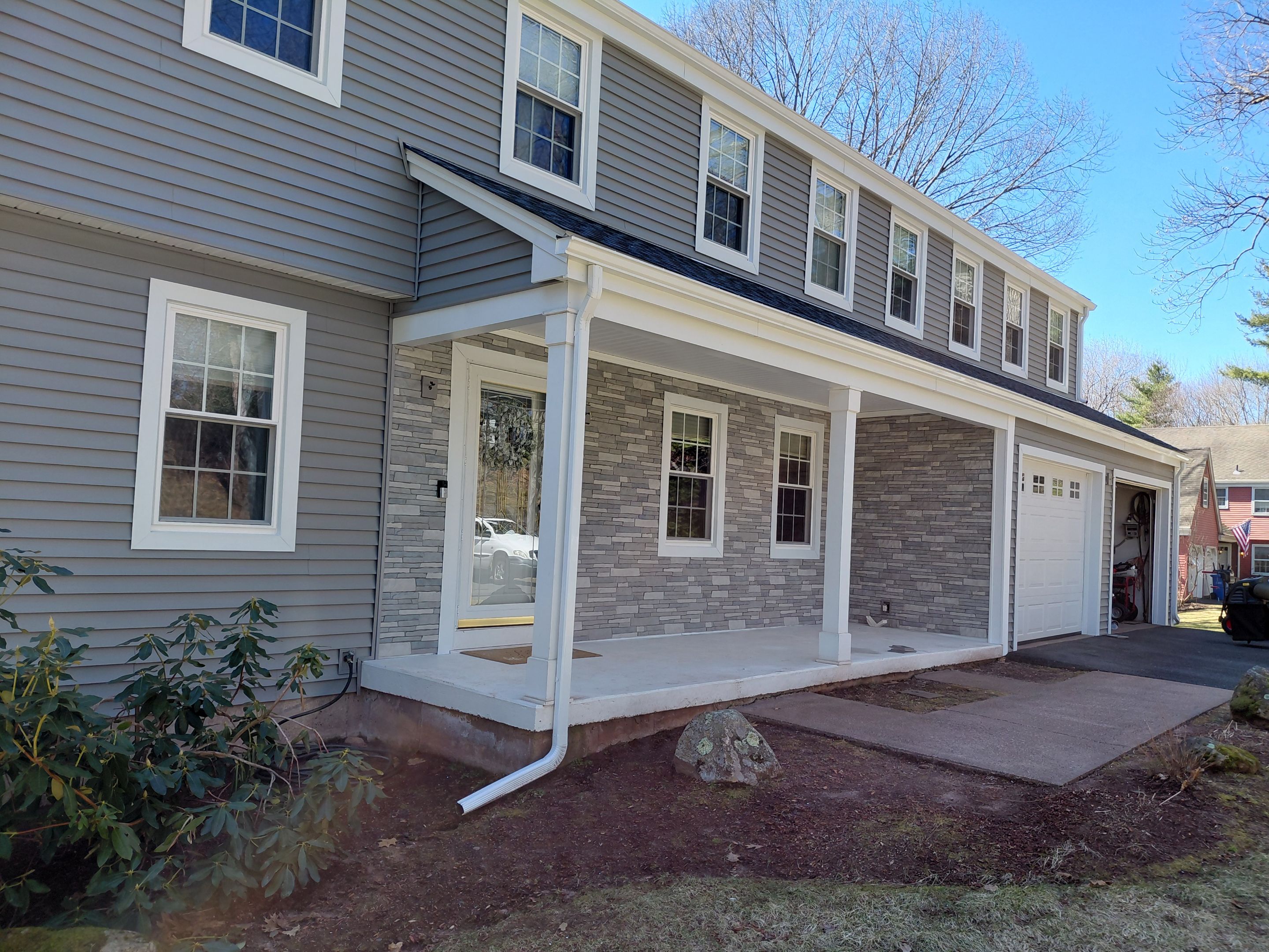 Glastonbury Exterior Renovation with Castle Stone Siding & Stone Entry Upgrade by Turner Home Improvement Contractors, LLC