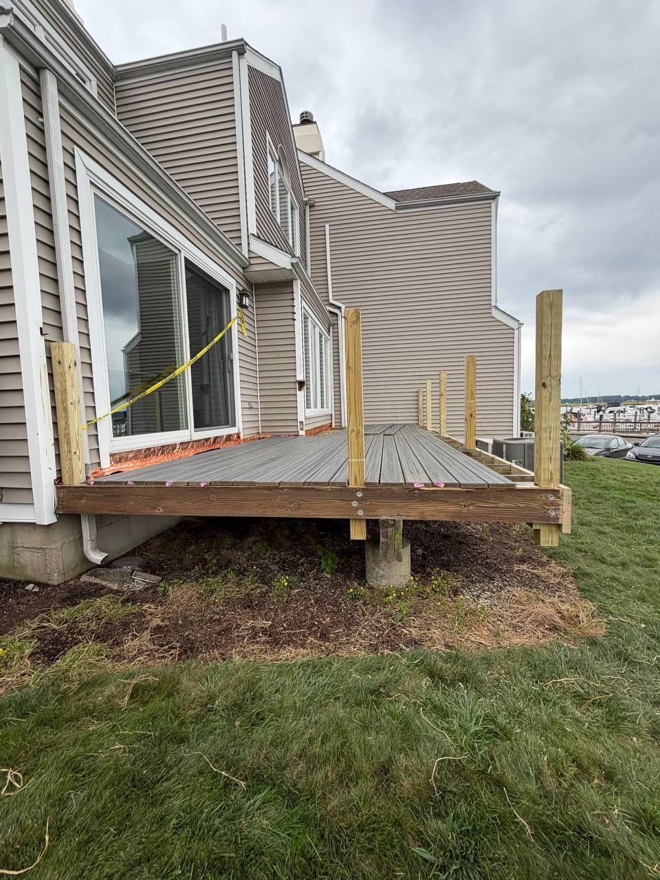 Deck replacement using trex Tropical Island mist and Pressure treated railings. by DiGiorgi Roofing and Siding Inc