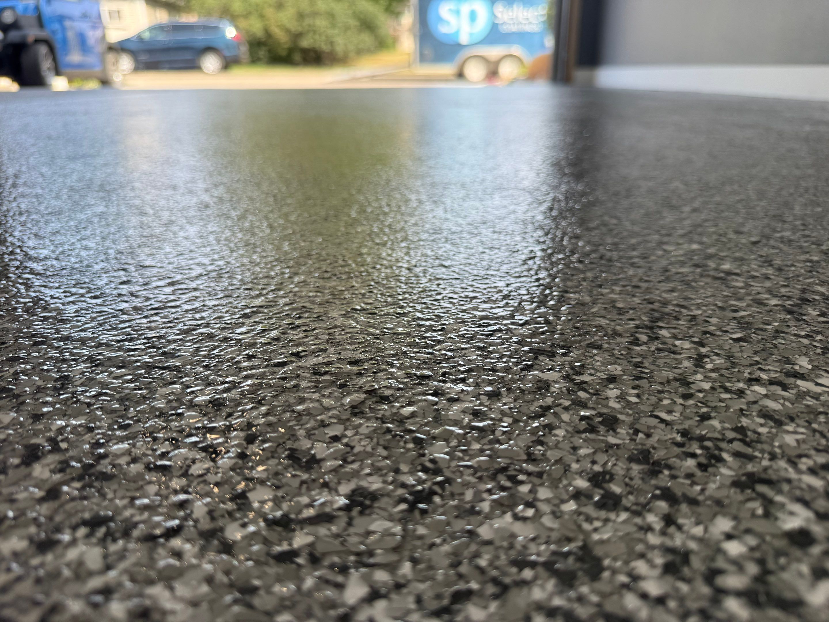 Custom Garage Floor Coating and Backyard Patio Refinishing in Tyndall by Select Painting, Coatings & Garage Cabinets