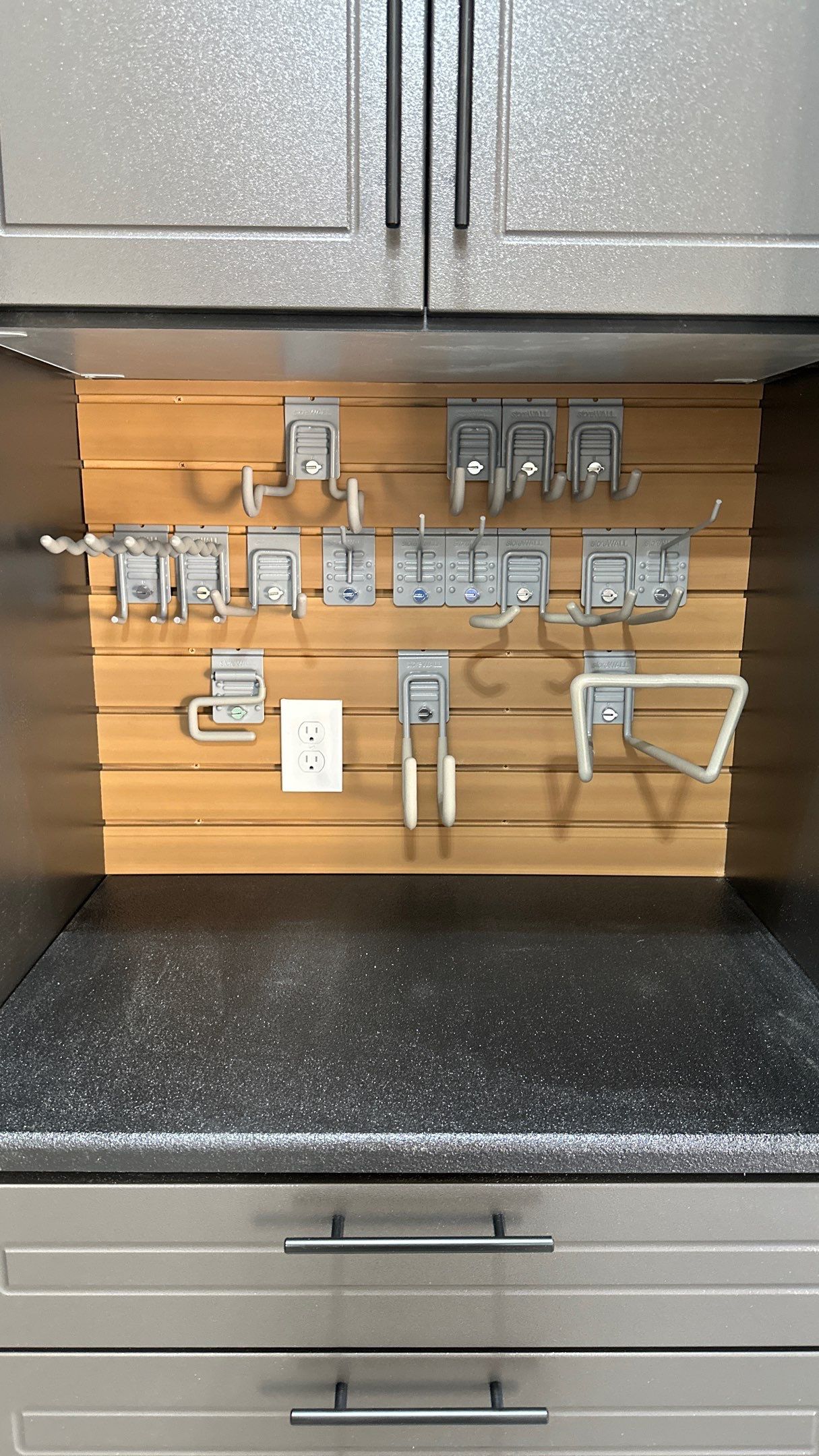 Mark S. chose Global Pine slotwall with his Pewter cabinets.  by Banner Garage