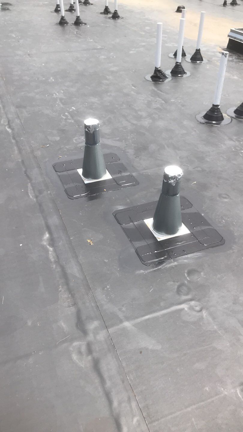 Commercial Roofing Installation using EPDM with white gutters by A Plus Exterior