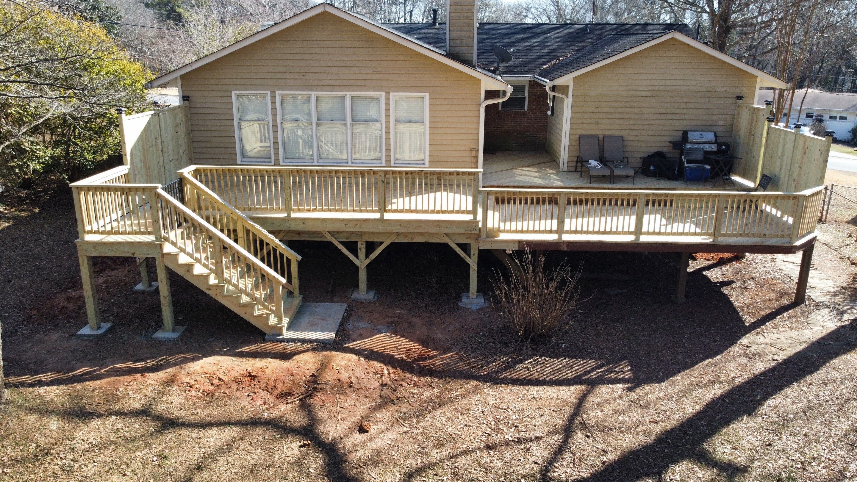 Elevated Pressure-Treated Wood Deck Extension in Marietta by Swift Home Renovations