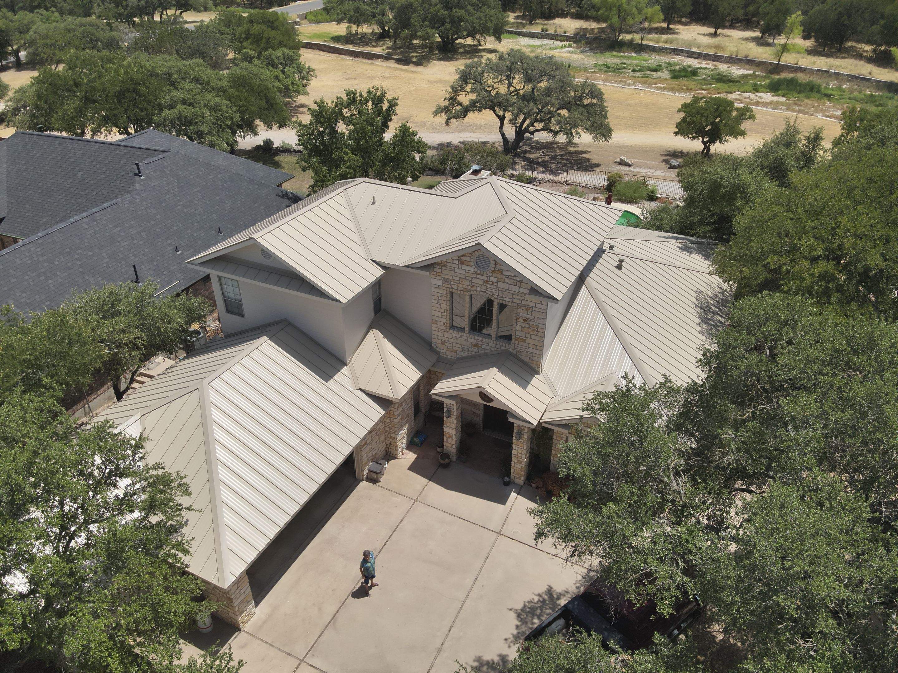 Residential Roof Replacement using 24 GA Double-Lock - Surrey Beige by Action Exteriors Austin