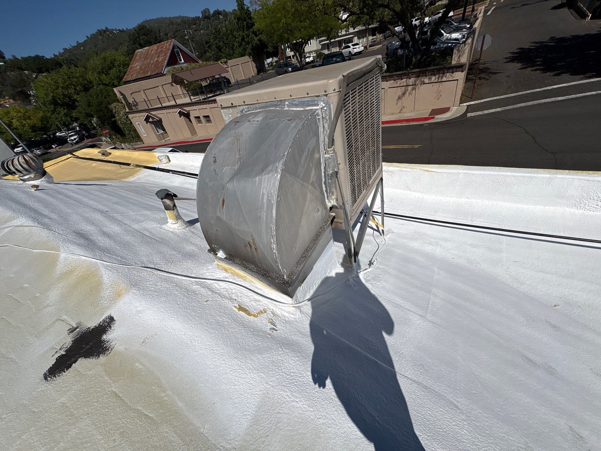 Foam and coatings on commercial roof by Straight Edge Roofing Inc
