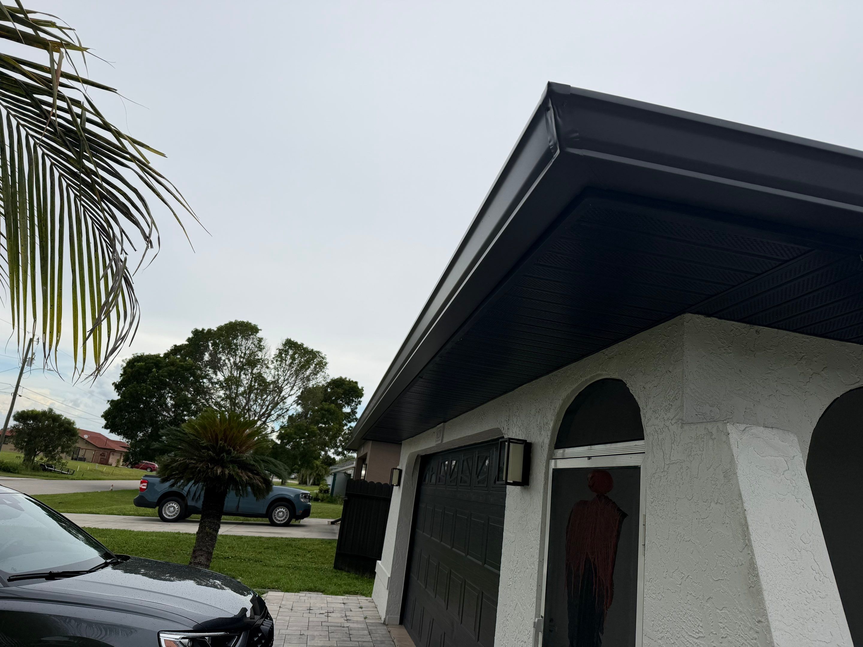 Black Seamless Gutters for a Modern Look in Cape Coral FL by Gutter Professors