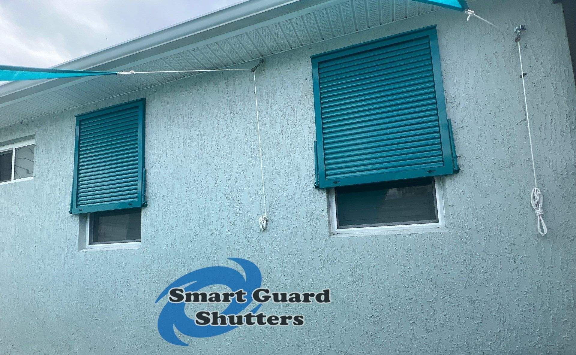 Impact Bahama Shutters in Water Blue by Smart Guard Shutters