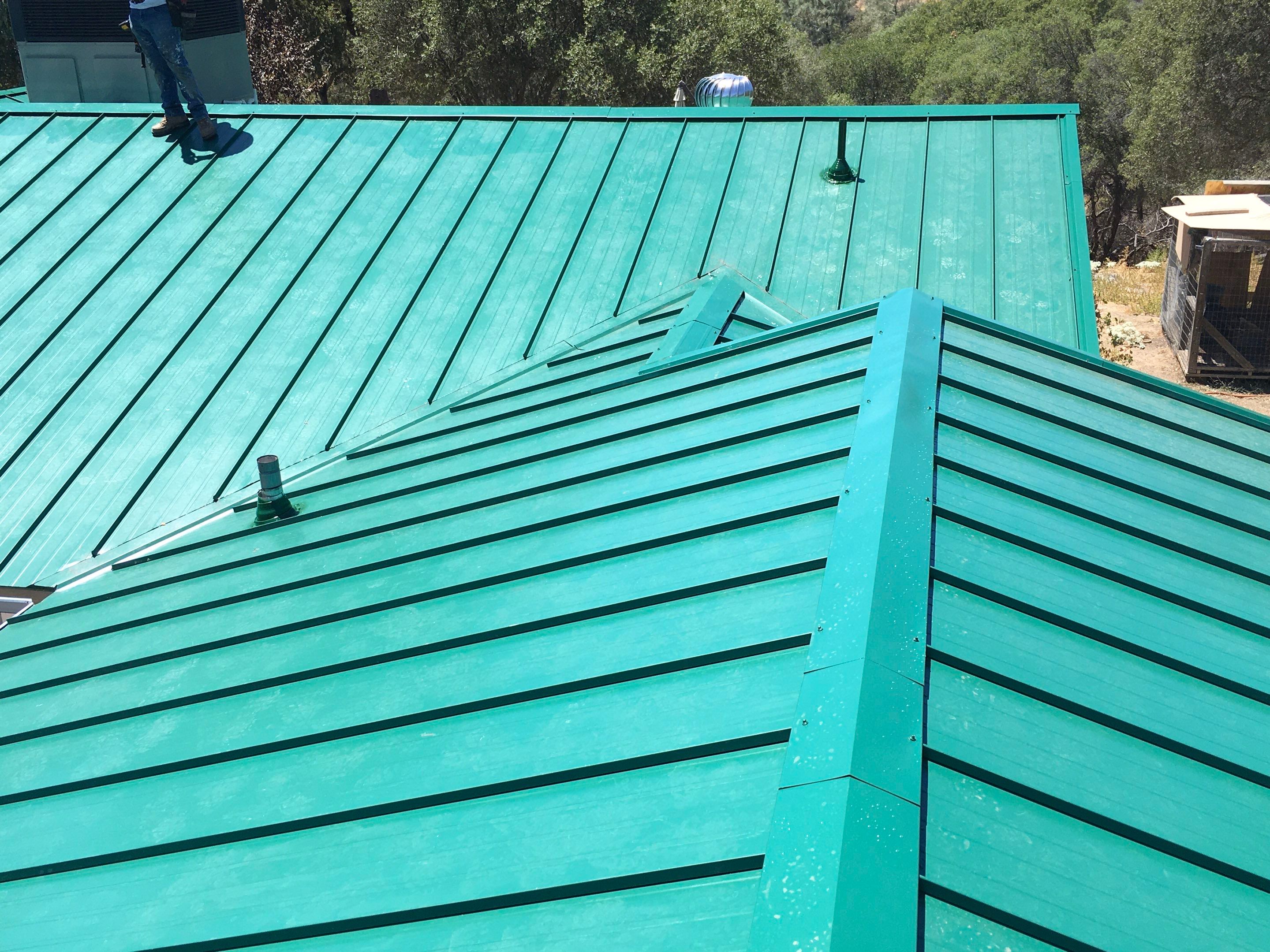 Metal roofing installation using Standing seam metal roofing system by Straight Edge Roofing Inc