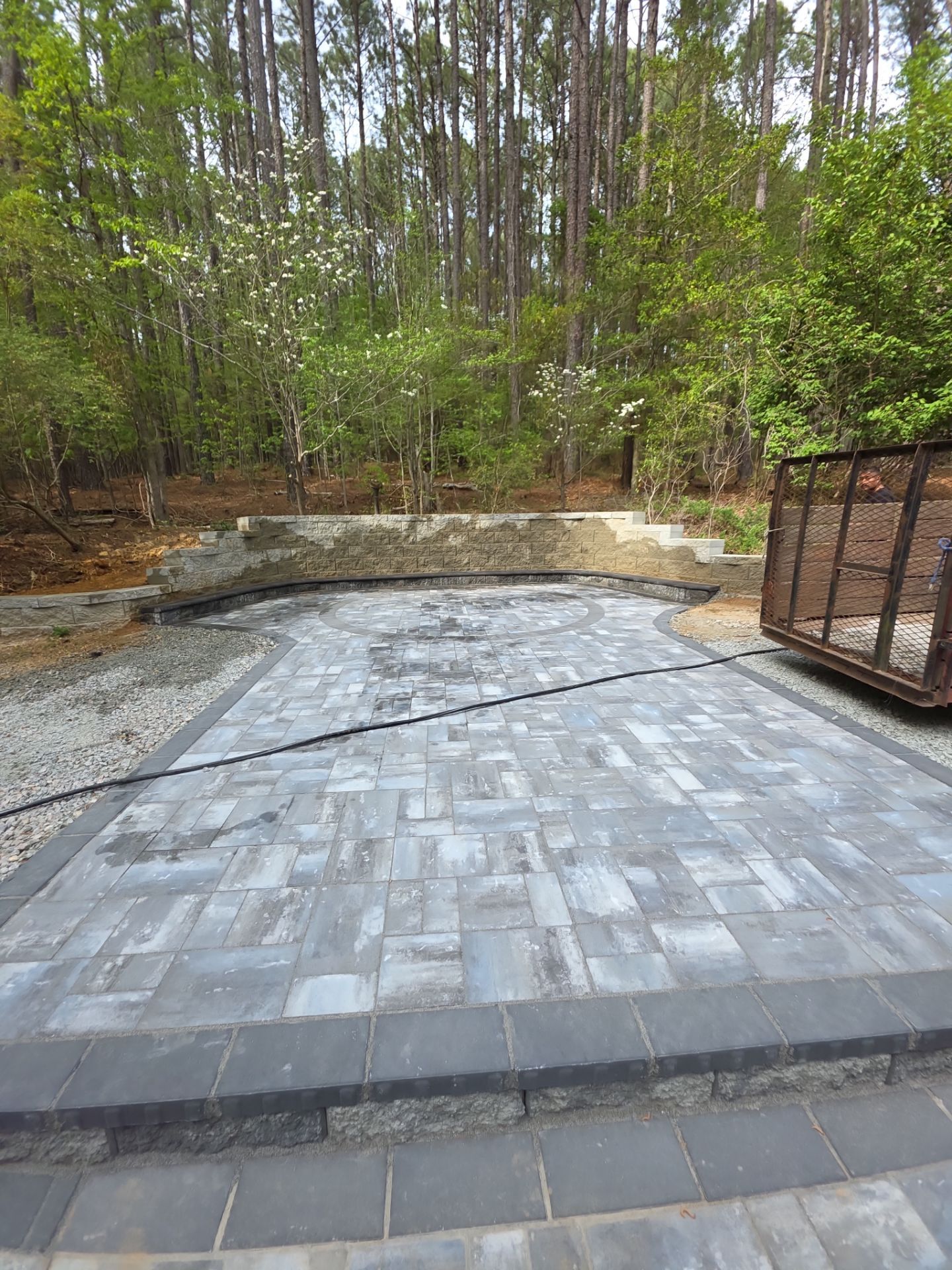 Pittsboro Outdoor Living Transformation – Retaining Wall, Paver Patio & Elevated Deck by Elite Remodeling and Design LLC