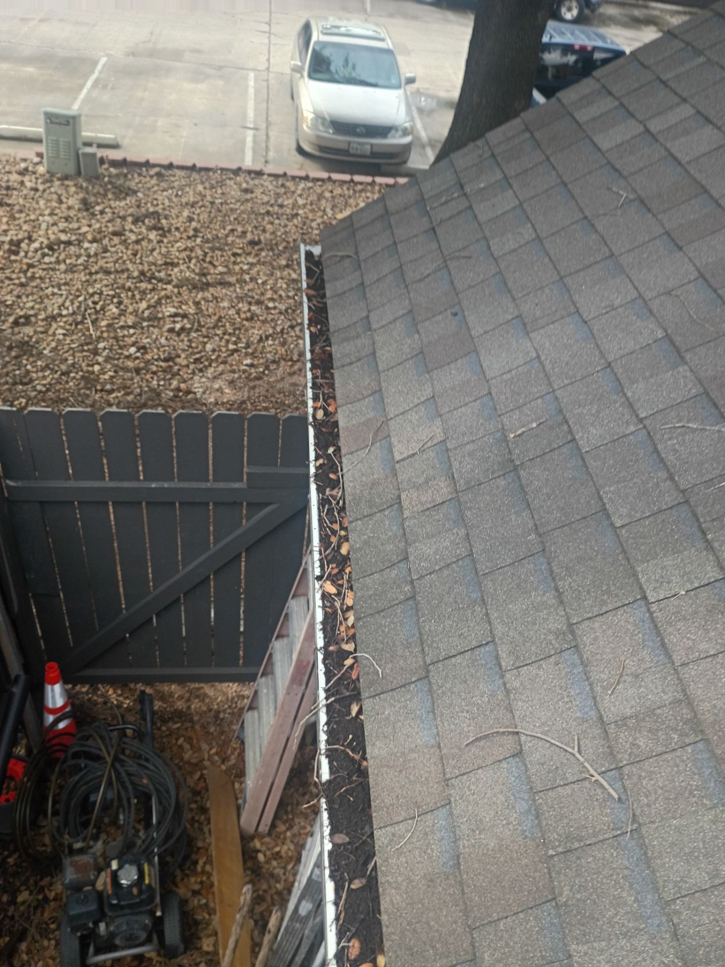 Commercial gutter cleaning San Marcos & New Braunfels, TX before photo with filled gutters