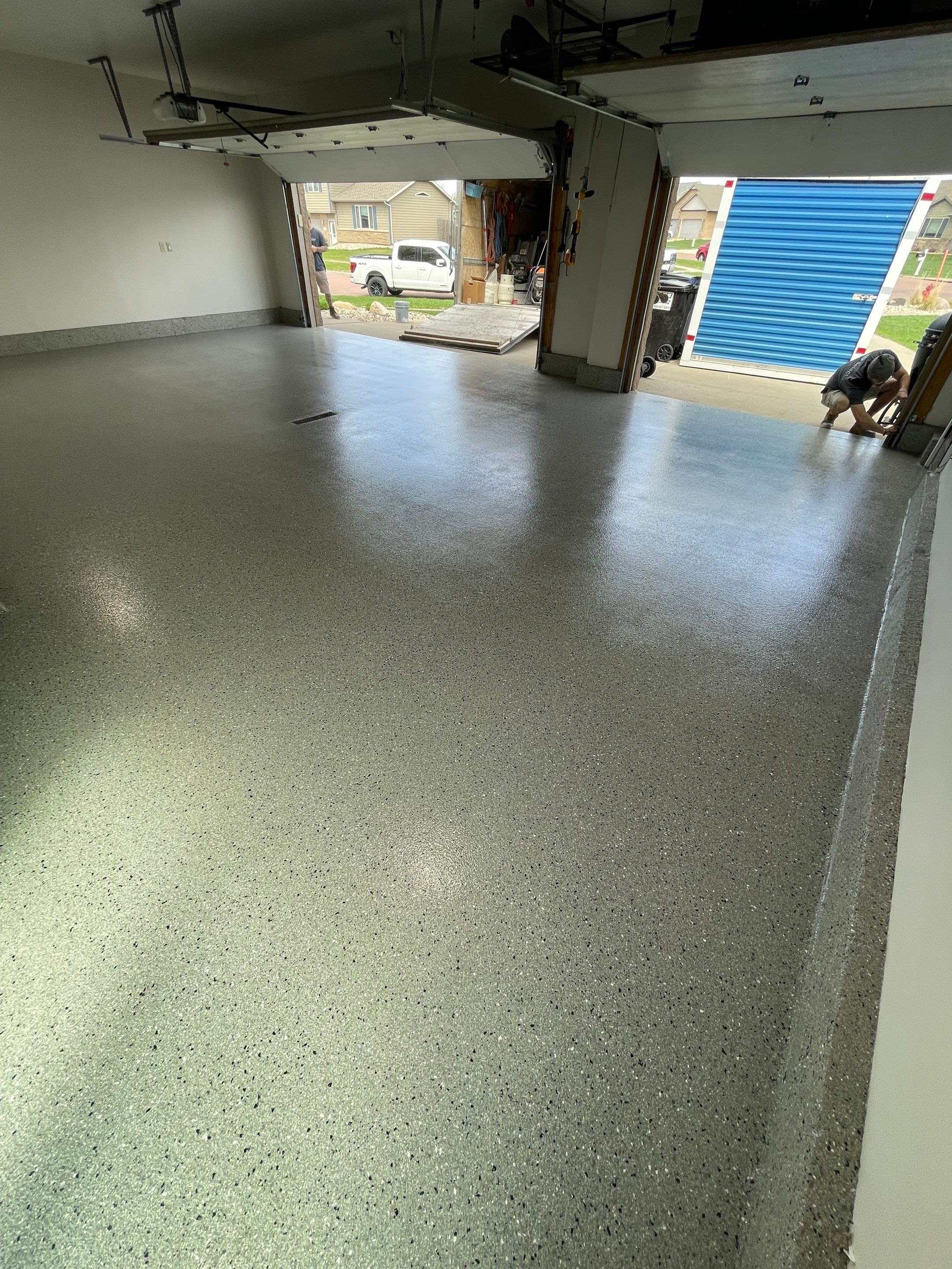 Residential Garage Floor Coating with Grey Speckled Epoxy Finish by Select Painting, Coatings & Garage Cabinets