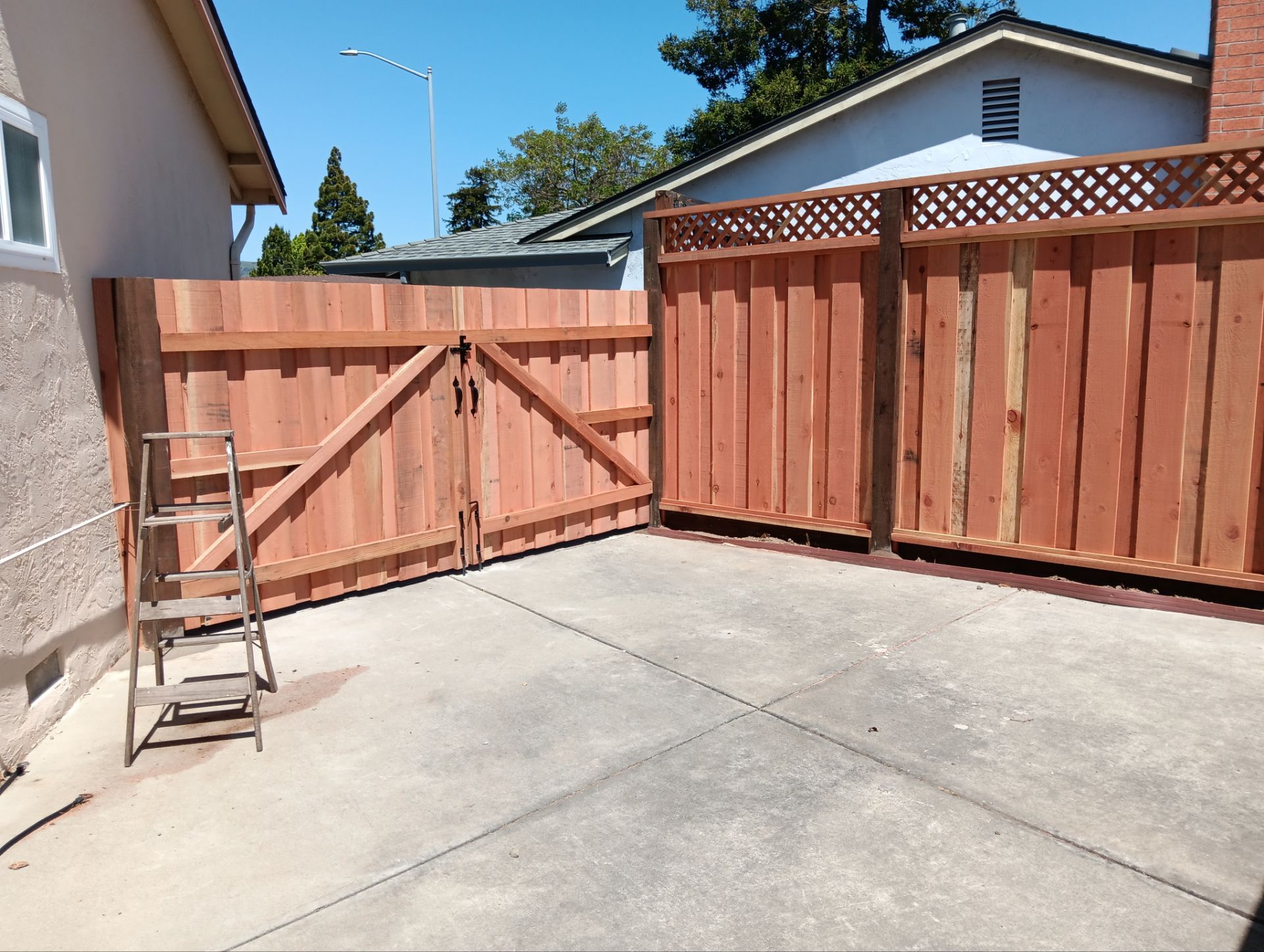 Board on Board with 1' Triple Lattice - 8' / 6' High by Fremont Fence Inc