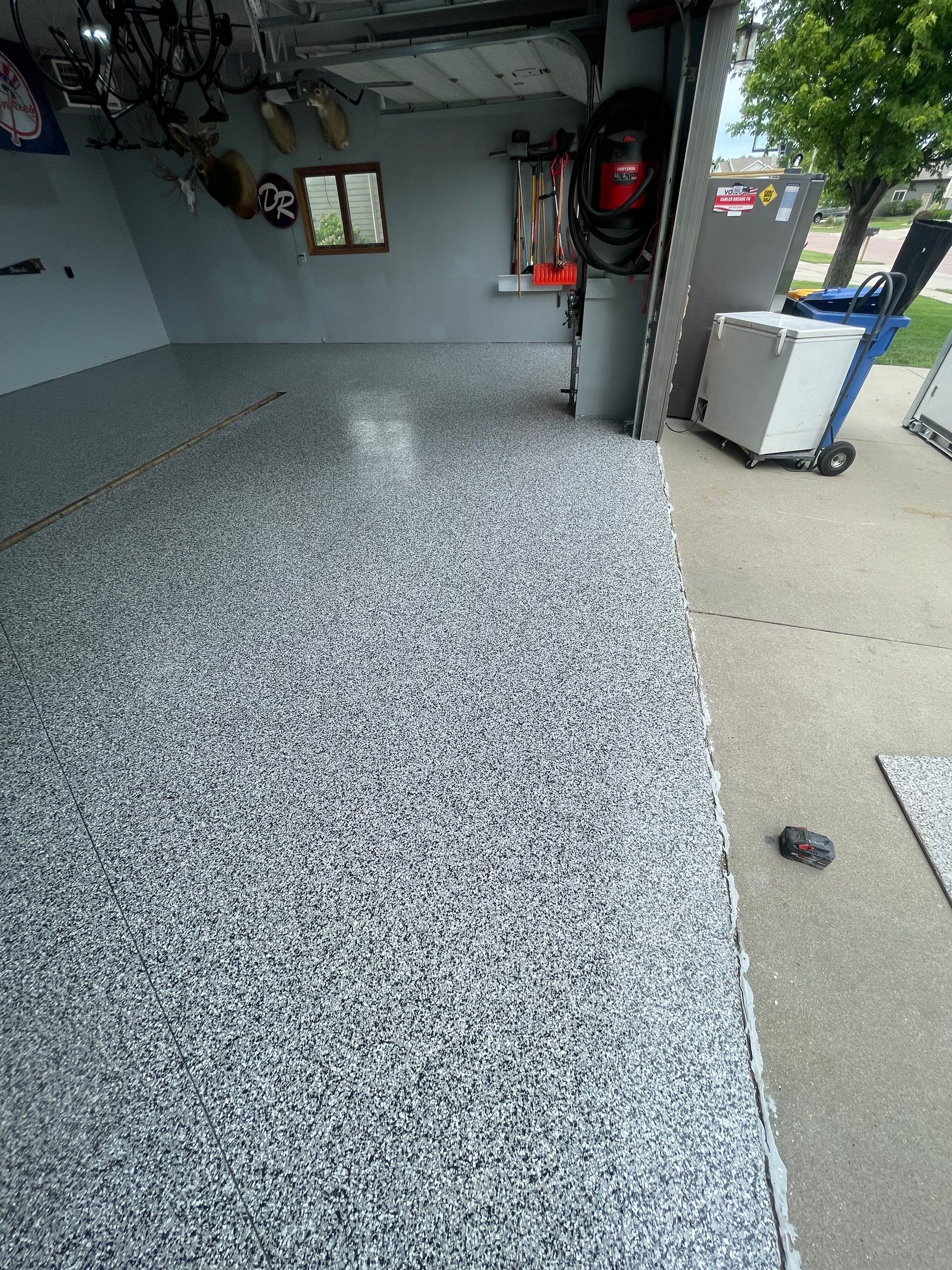 Full Garage Floor Epoxy Coating Installation in Dell Rapids by Select Painting, Coatings & Garage Cabinets