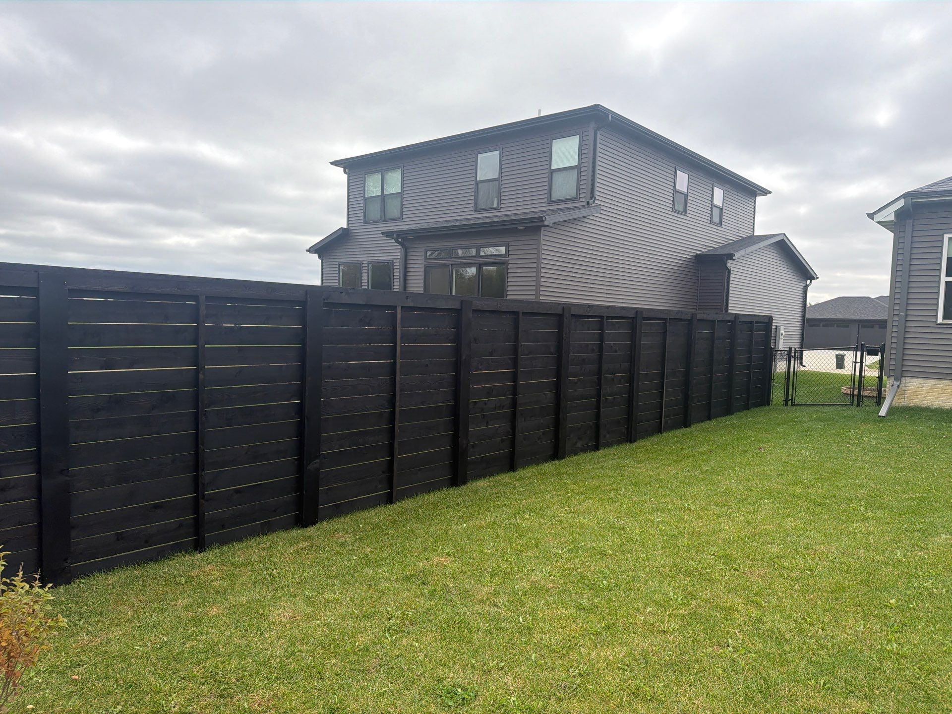 Modern Horizontal Wood Privacy Fence Installation in Cedar Falls by Perfect Picket Fence and Stain