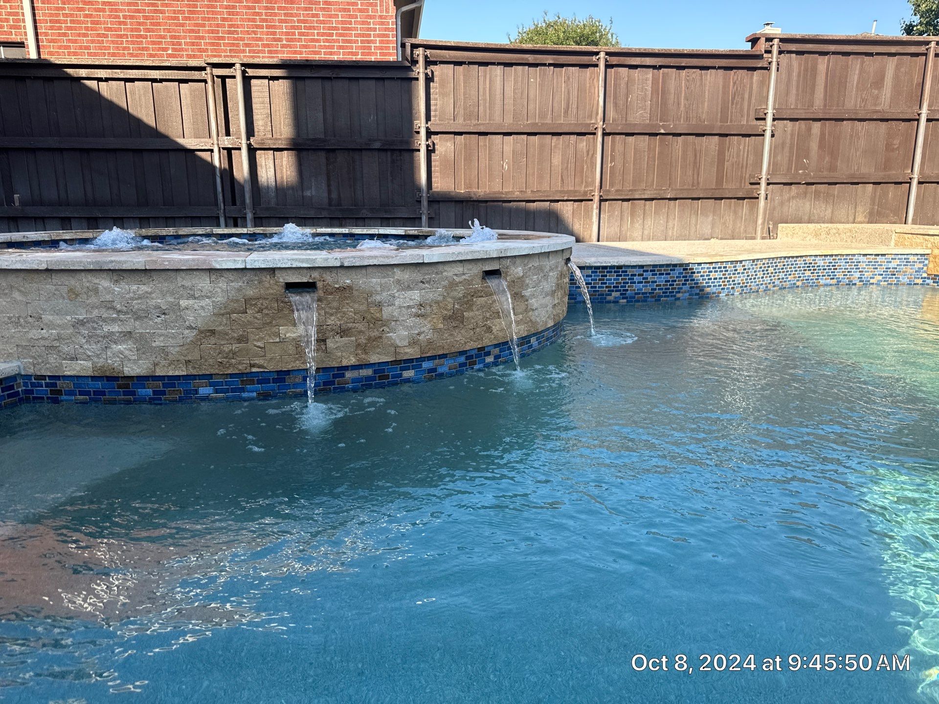 Freeform Pool and Spa with Raised Stone Water Wall by Pinnacle Pools and Spas - DFW