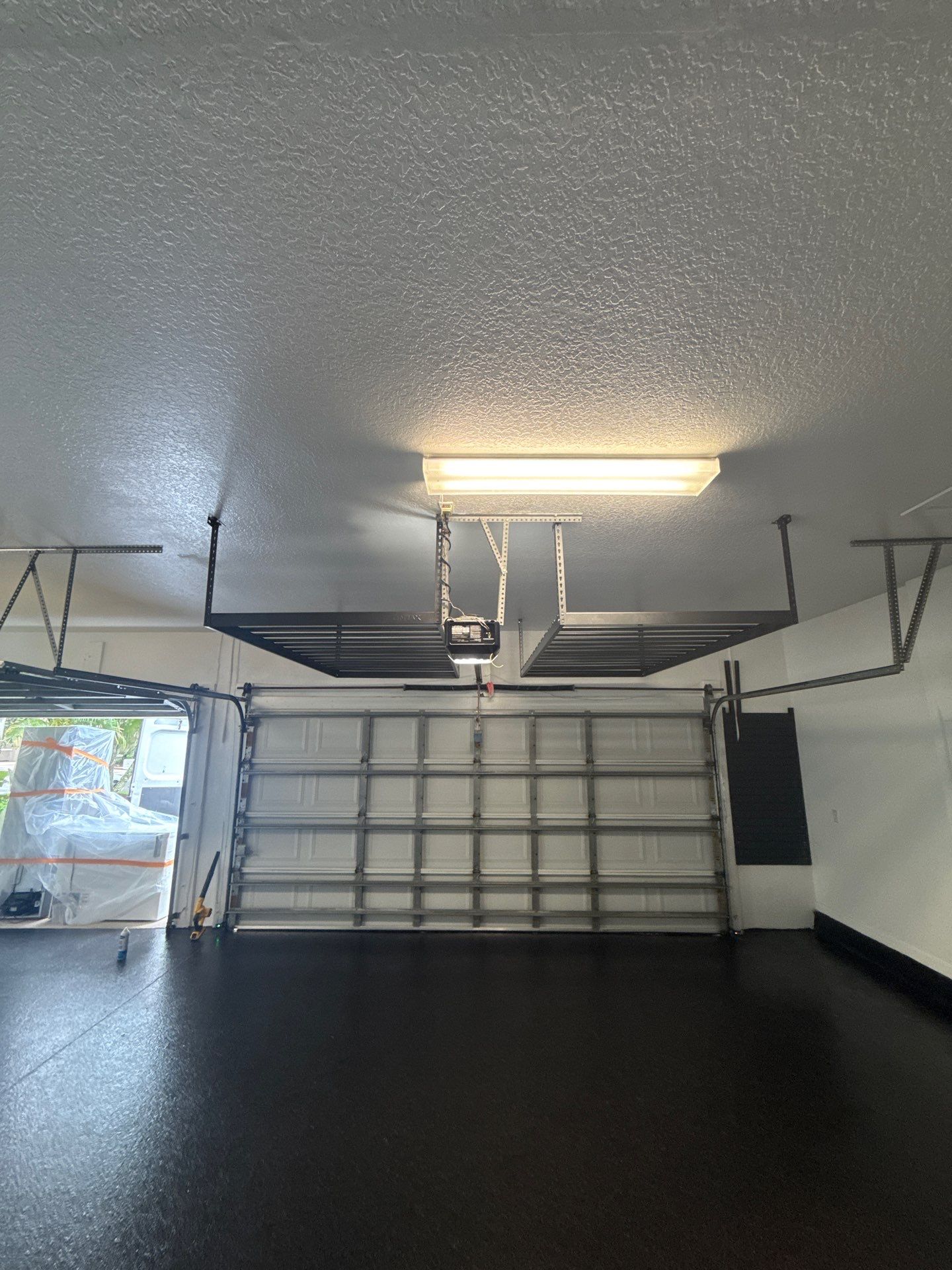 Tampa Garage Floor Coating and Overhead Storage Rack Installation by Square 1 Garage and Closet Solutions