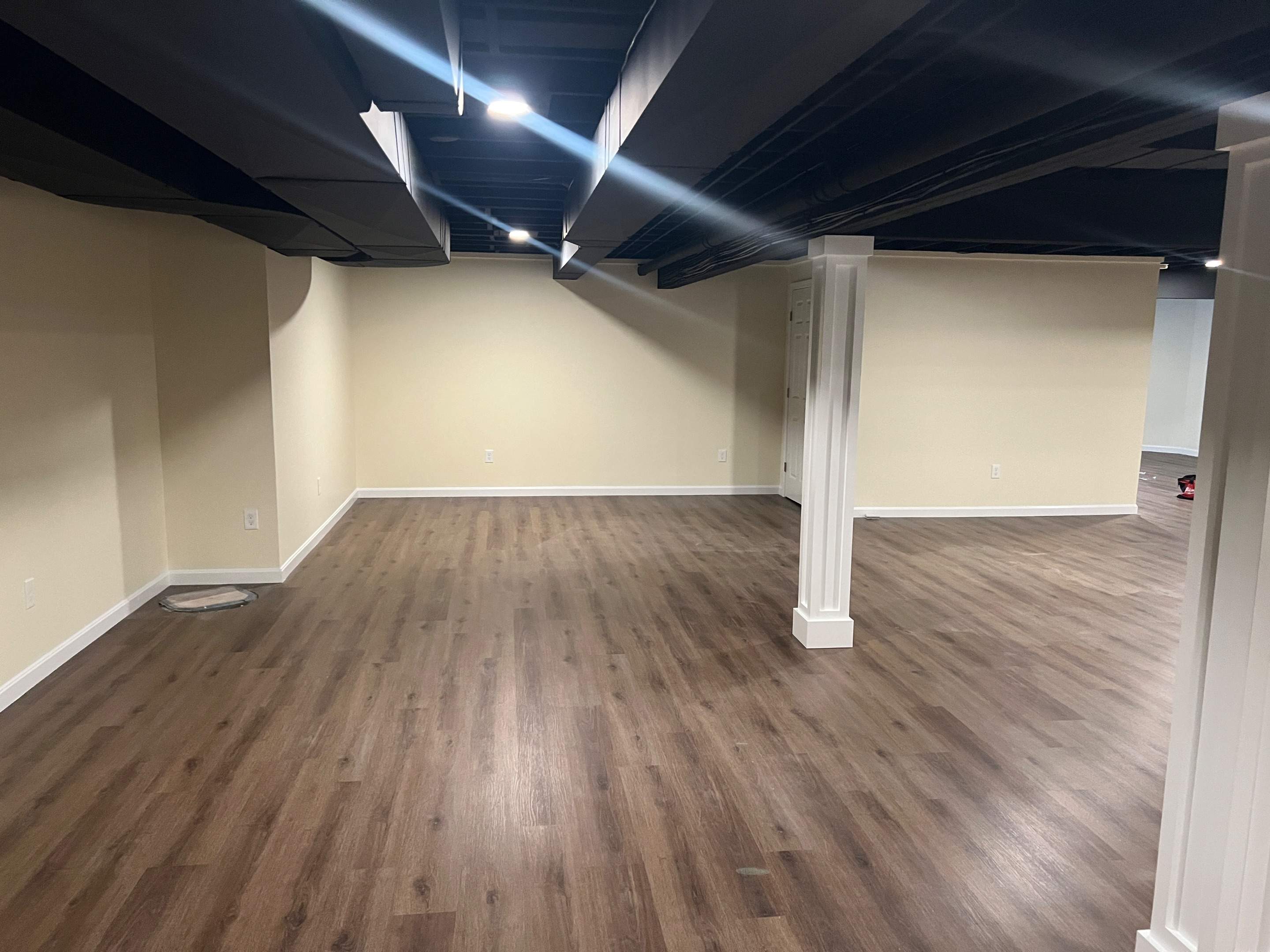 Basement Remodel w/ LVP Flooring & Exposed Ceiling by Chagnon Building & Remodeling LLC