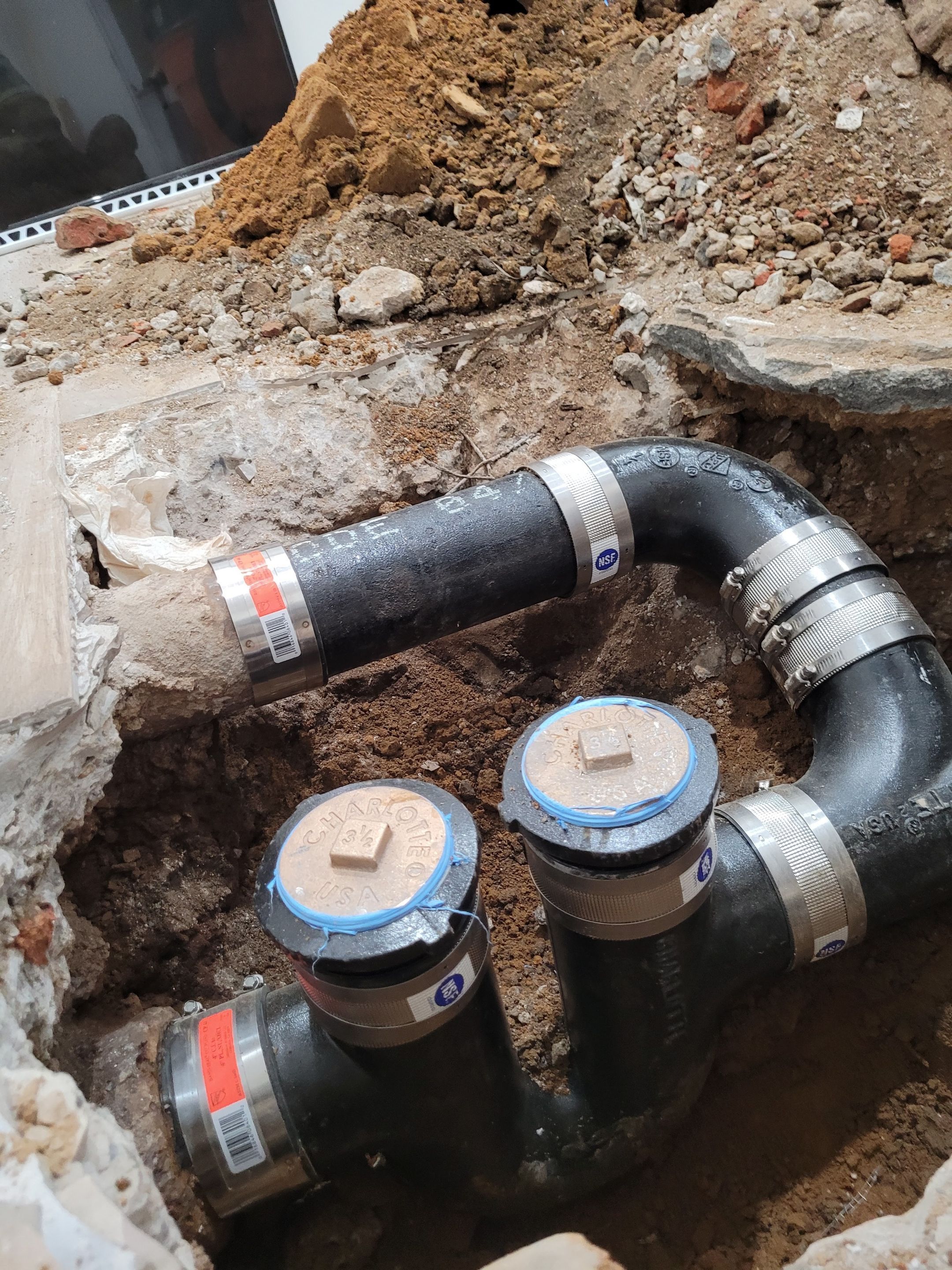 The replacement of a crumbing leaky house u-trap in basement by WG's Remodeling Inc