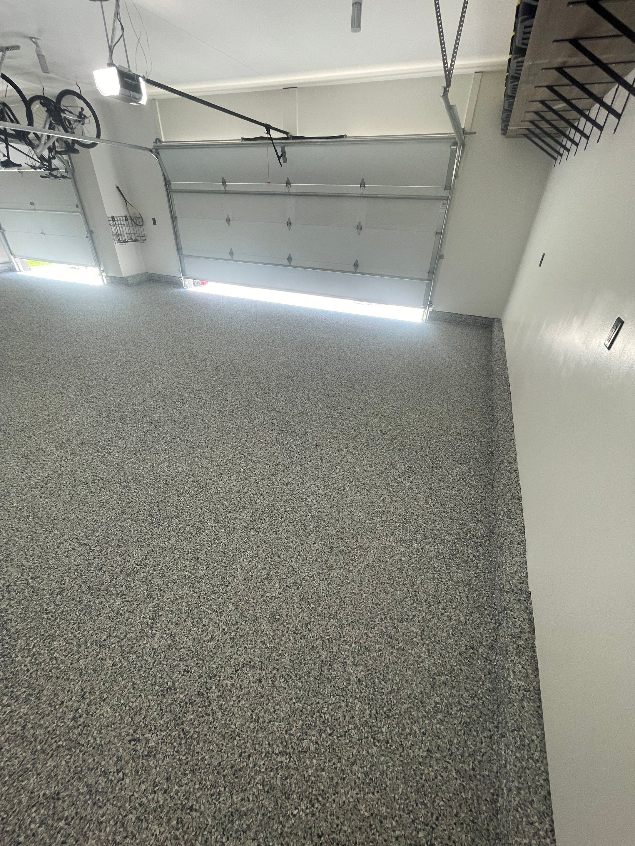 Tidal Wave Flake Garage Floor Installation in Sioux Falls by Select Painting, Coatings & Garage Cabinets