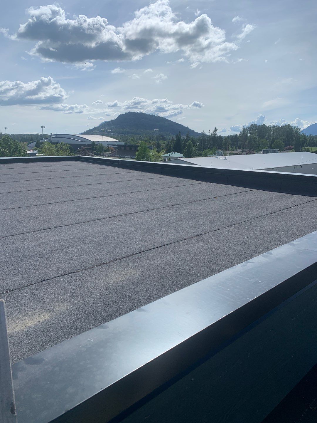 Large apartment with sbs, shingles and prolok metal  by Top Notch Roofing Inc