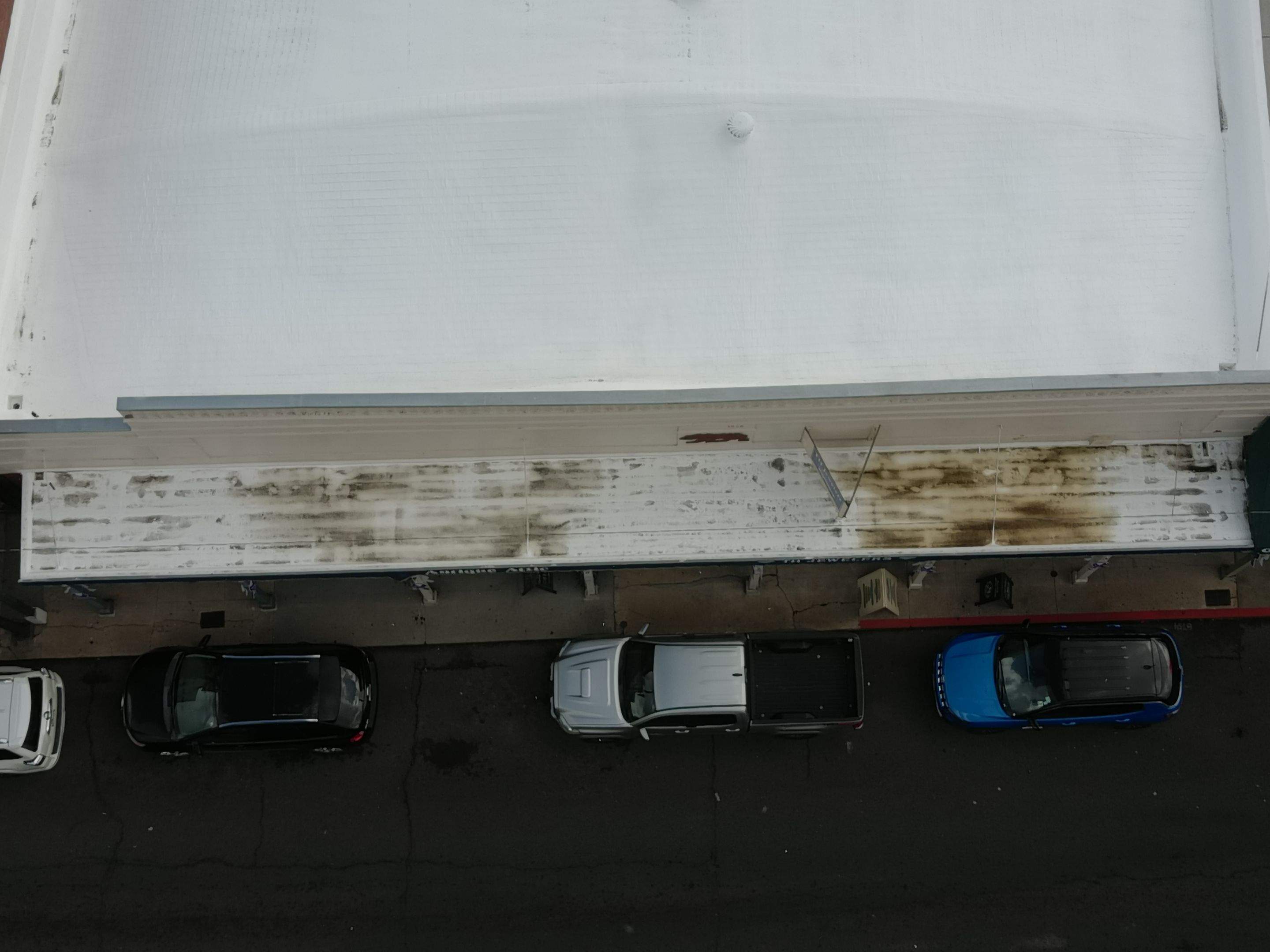 Foam and coatings on commercial roof by Straight Edge Roofing Inc
