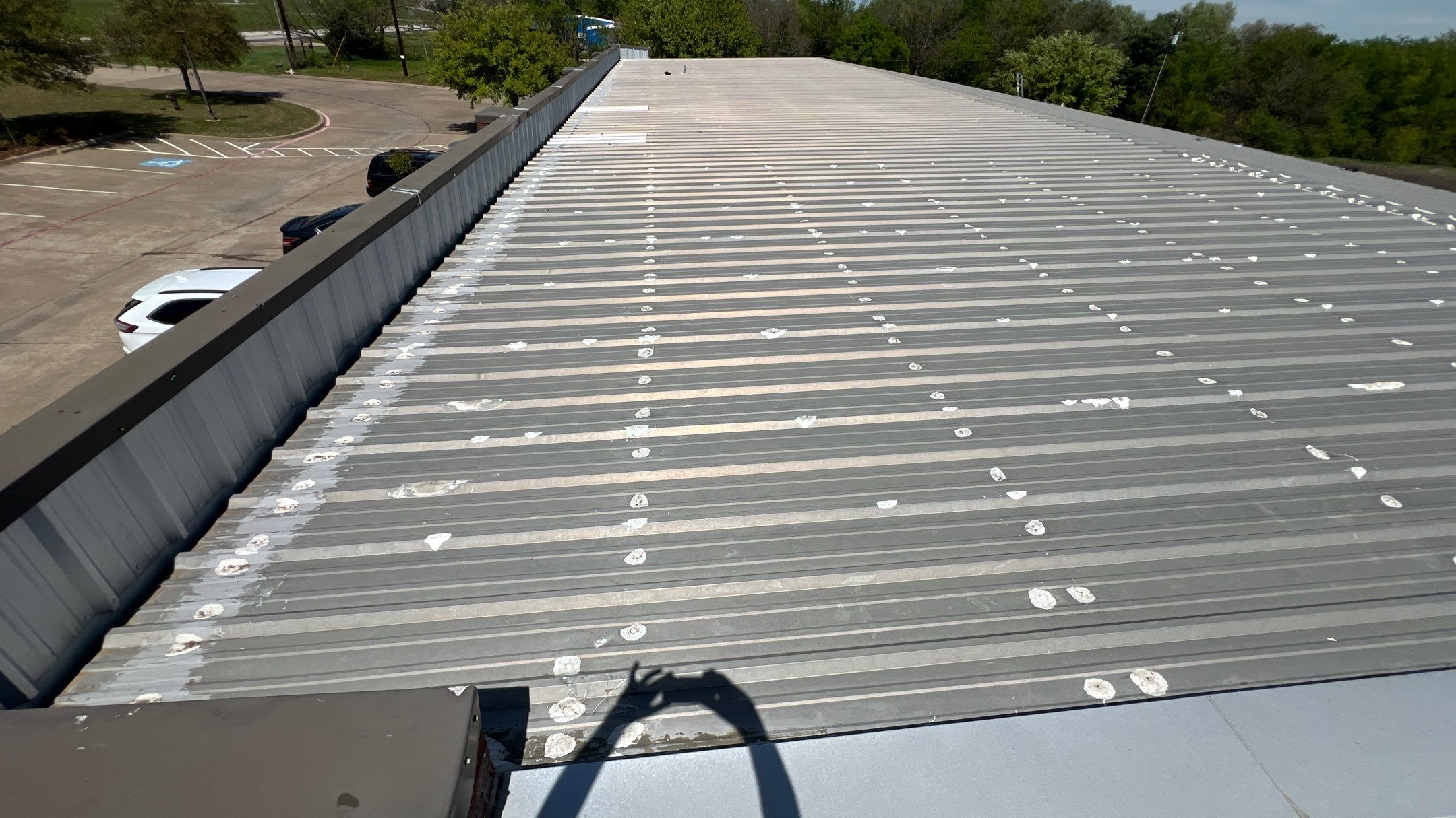 Commercial Roofing Installation using TRP #924 Eterna-Sil Premium Silicone Roof Coating by Harvey Roofing & Construction