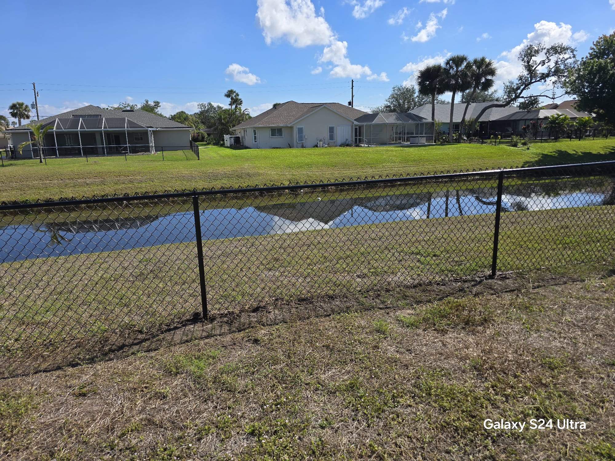 Waterfront Black Chain Link Fence Installation in Rotonda West by True Fence LLC