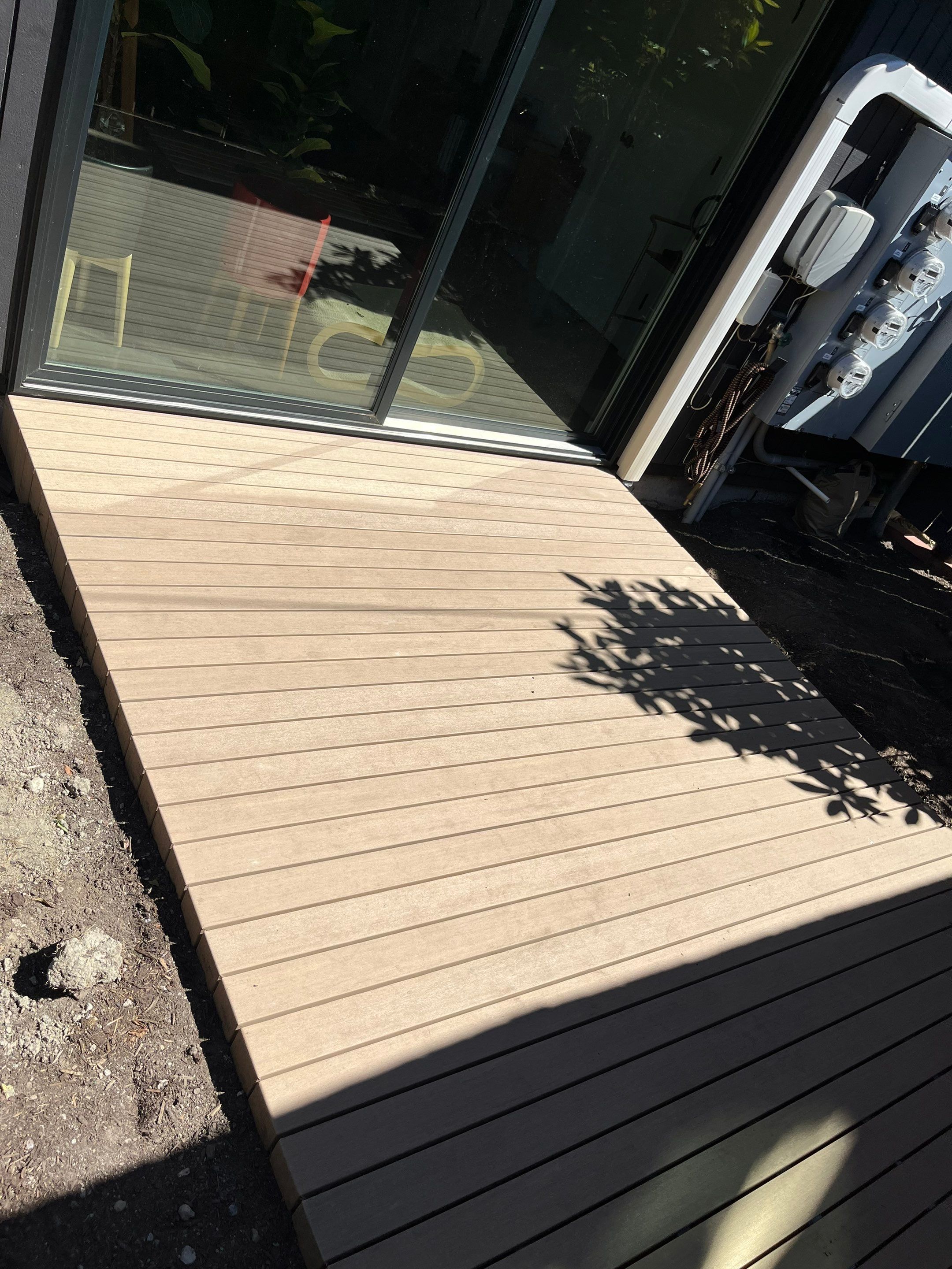 Modern Backyard Deck by Alki deck builders 