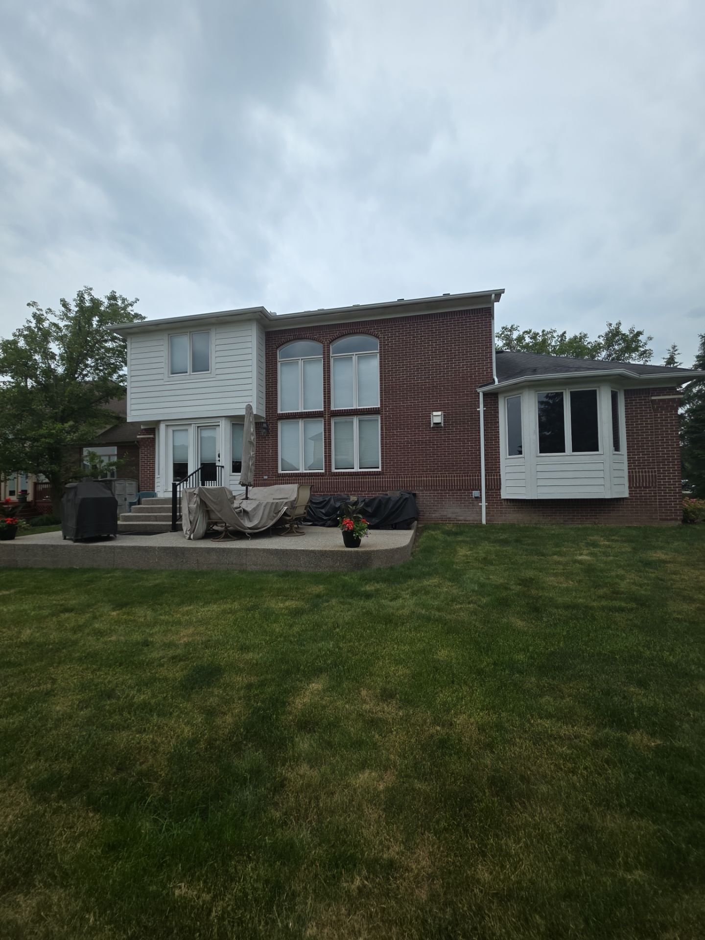 Siding and Trim Repair and Exterior Painting for a Macomb Brick Residence by Top Shelf Painter