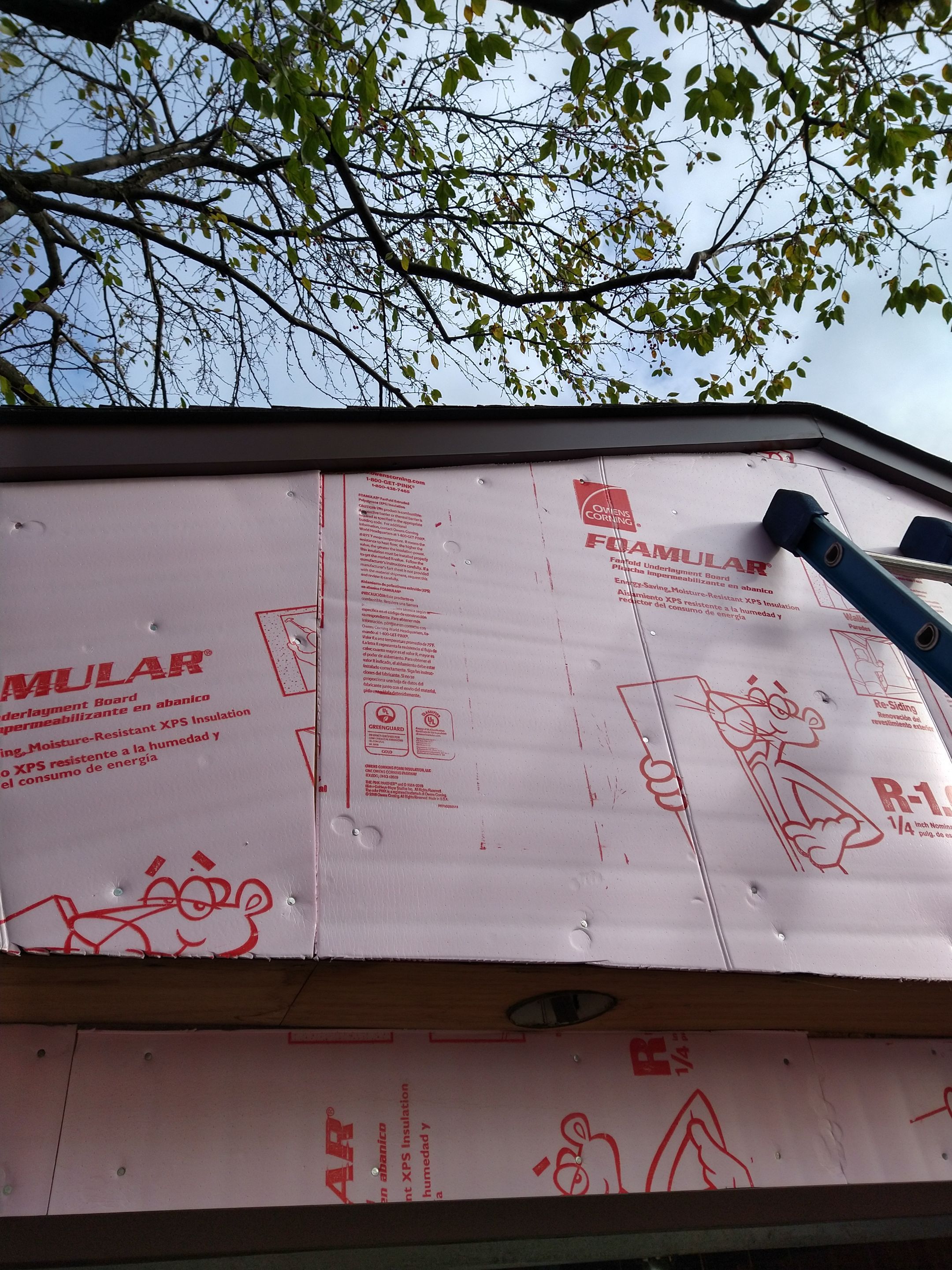 Siding Installation using Norandex woodsman dl-5 white woodgrain vinyl by Absolute Roofing and Construction