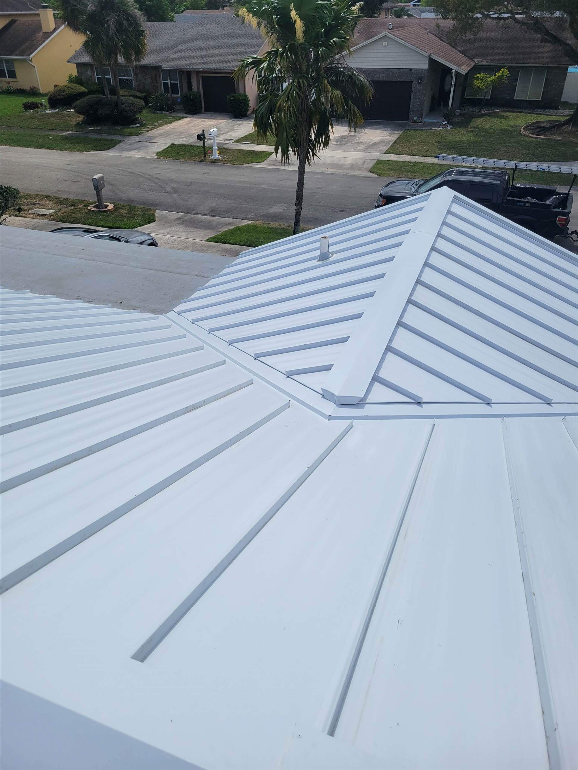 Standing Seam Metal & Flat Re-Roof using 1.5" Nail Strip 24ga Solar White Kynar Coated Standing Seam Metal Panels by Morton Roofing, Inc.