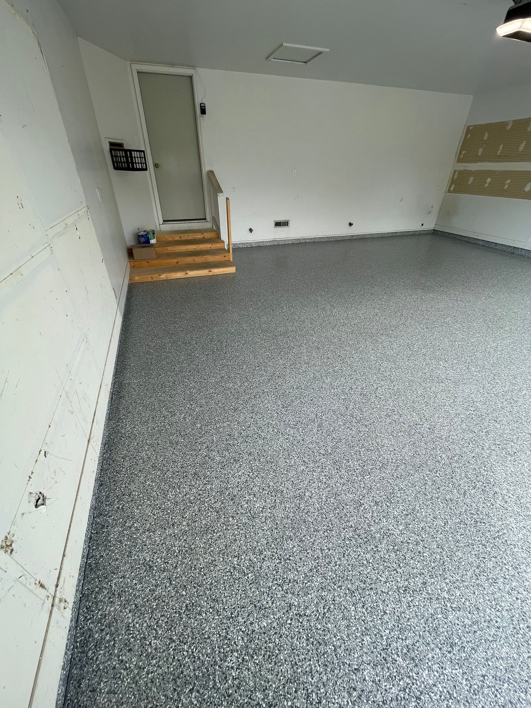 Grey Speckled Concrete Coating for Residential Garage in Yankton by Select Painting, Coatings & Garage Cabinets